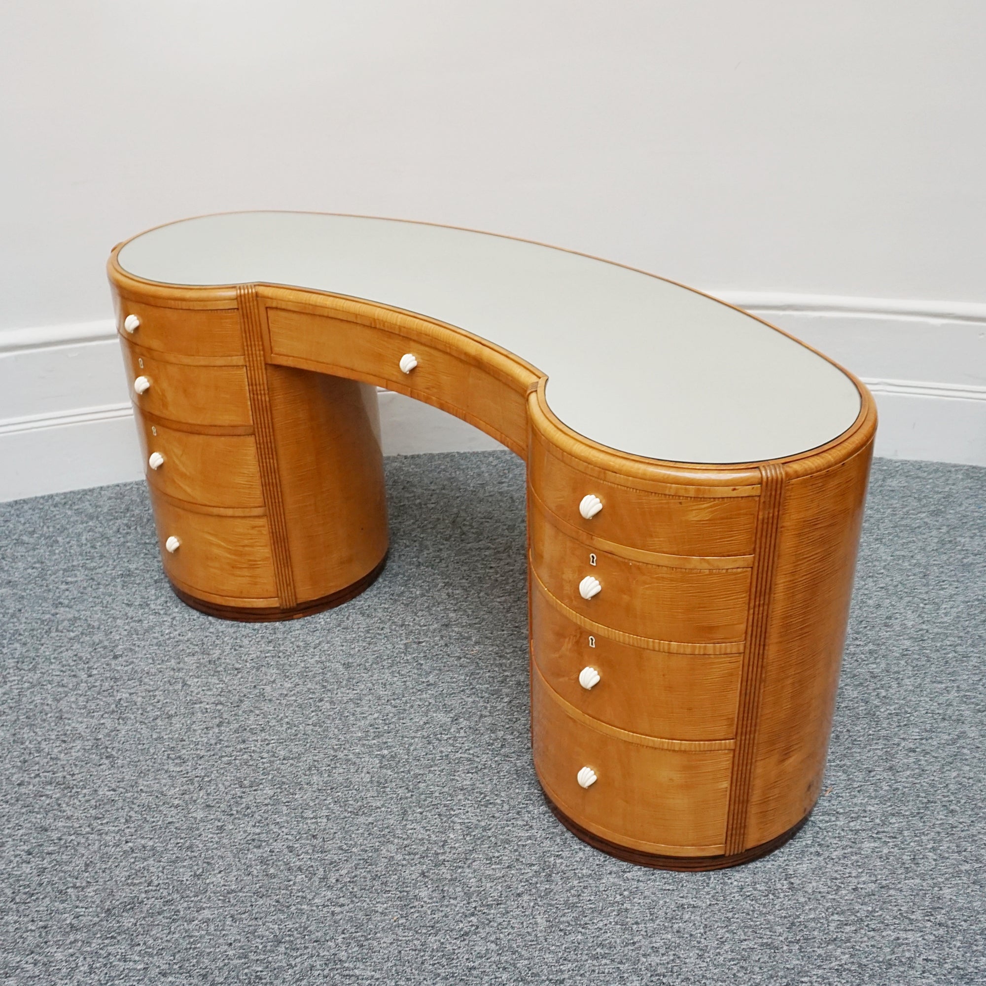 An Art Deco Desk by Betty Joel. Satin birch veneered with macassar ebony banding to base. Glass mirrored top with original ivory hand carved shell handles. 1930 dressing table, art deco desk - Jeroen Markies Art Deco