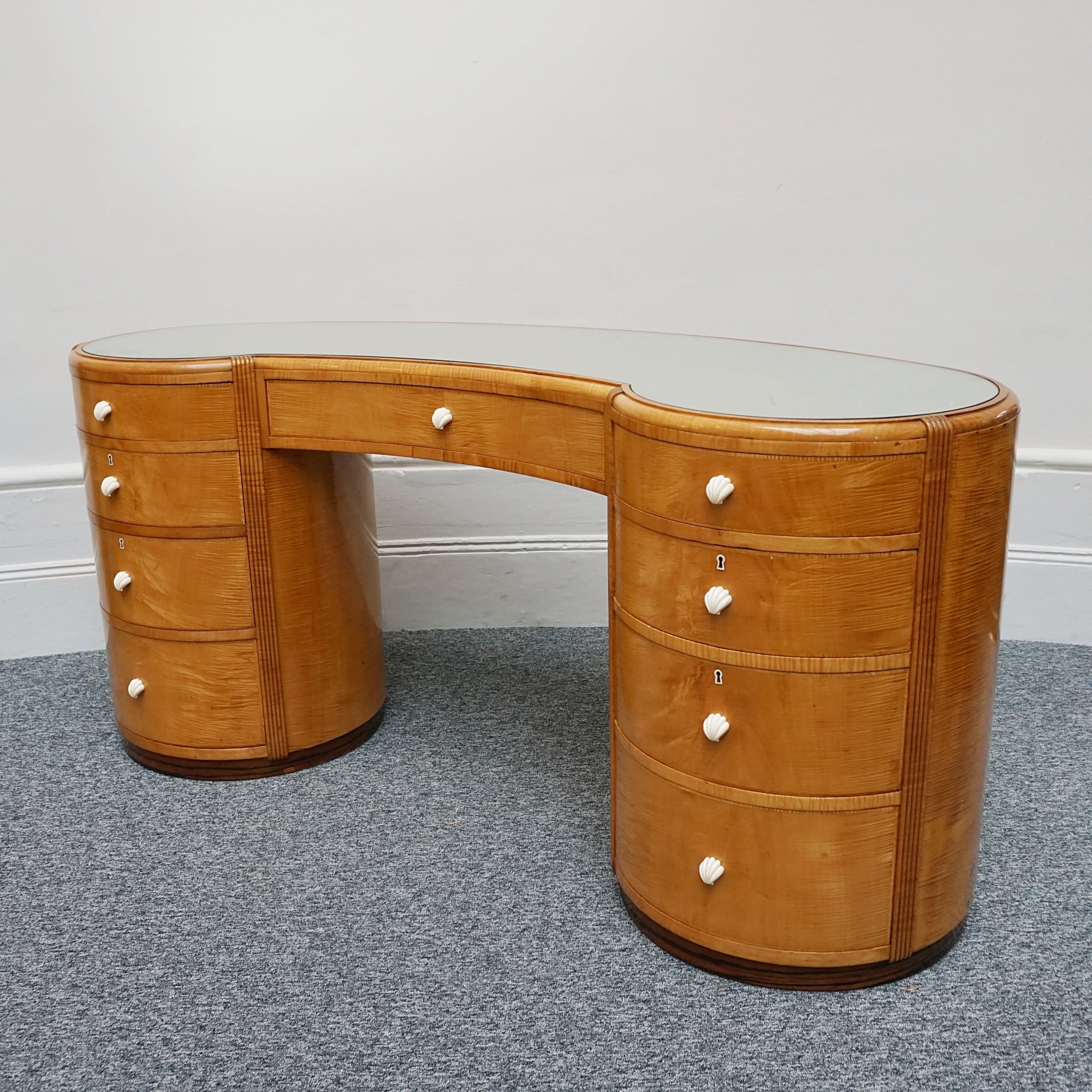 An Art Deco Desk by Betty Joel. Satin birch veneered with macassar ebony banding to base. Glass mirrored top with original ivory hand carved shell handles. 1930 dressing table, art deco desk - Jeroen Markies Art Deco