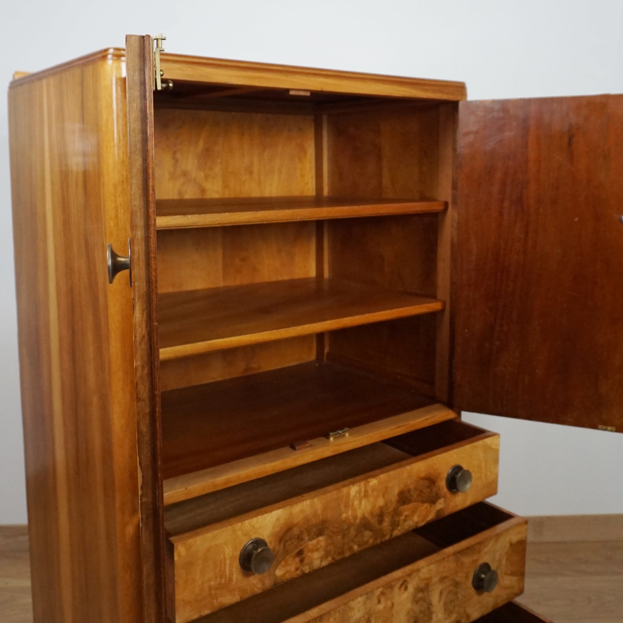 Wooden cabinet with open doors and drawers on a white background