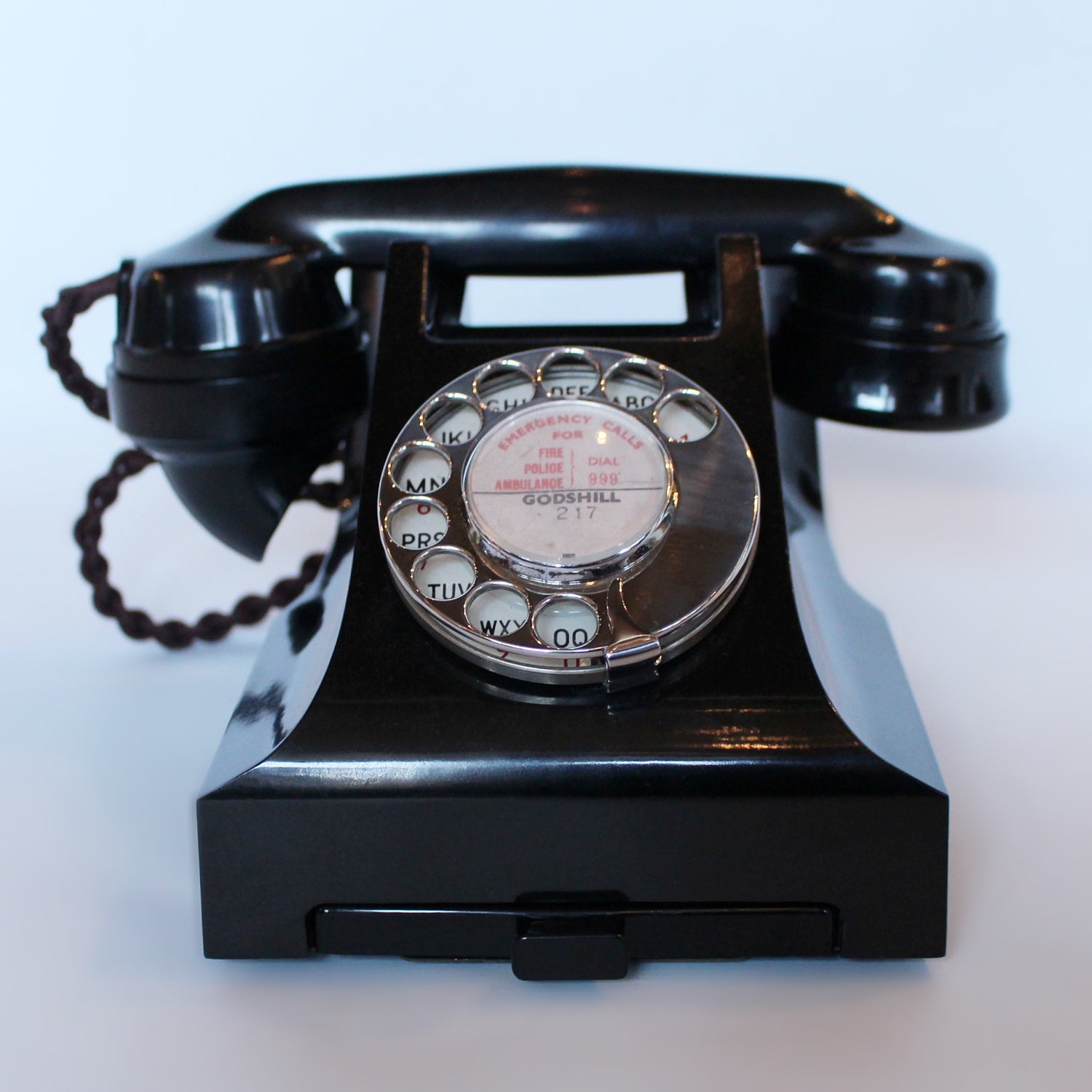 An original GPO telephone in black bakelite. With integral drawer.