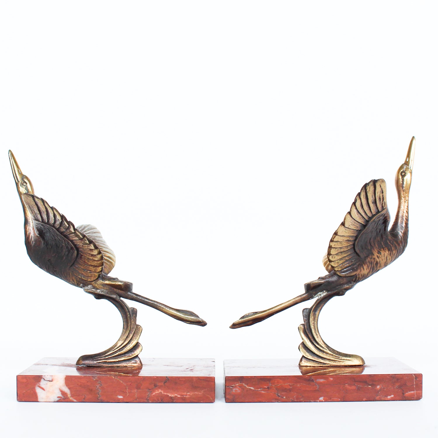 A pair of Art Deco, bronze bookends in the form of two marabou storks. Set over marble plinths.