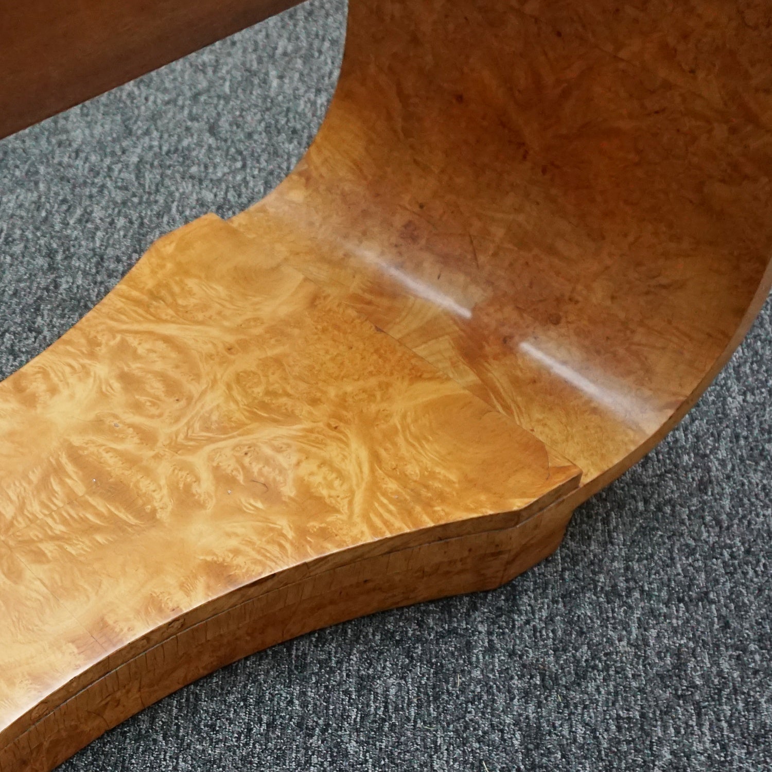 An art deco dining table with 6 chairs by Harry & Lou Epstein. The table top and cloud back armchairs are veneered in burr walnut. The chairs are upholstered in cream faux suede.
