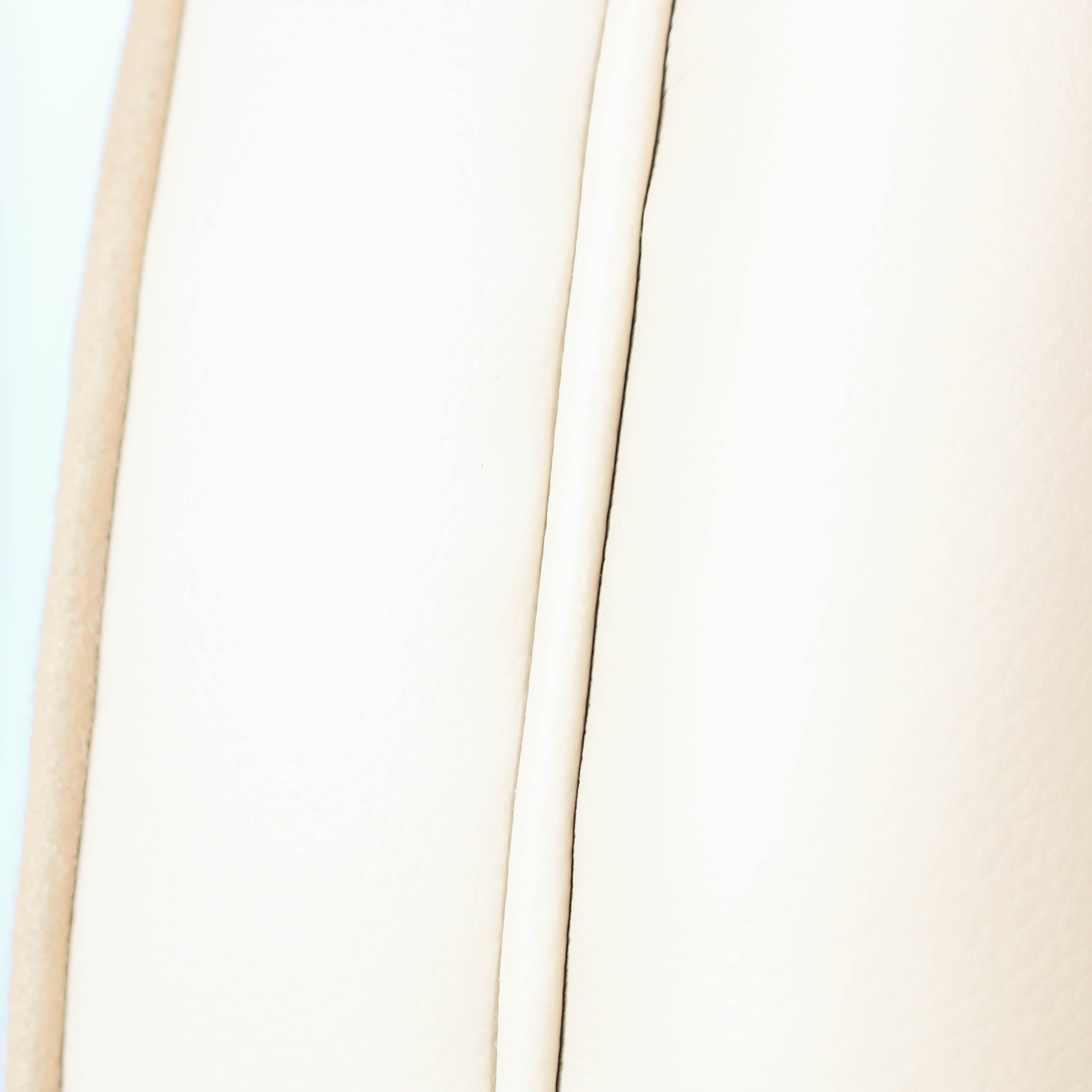 A pair of Art Deco, cloud back armchairs, re-leathered in cream leather at Jeroen Markies.