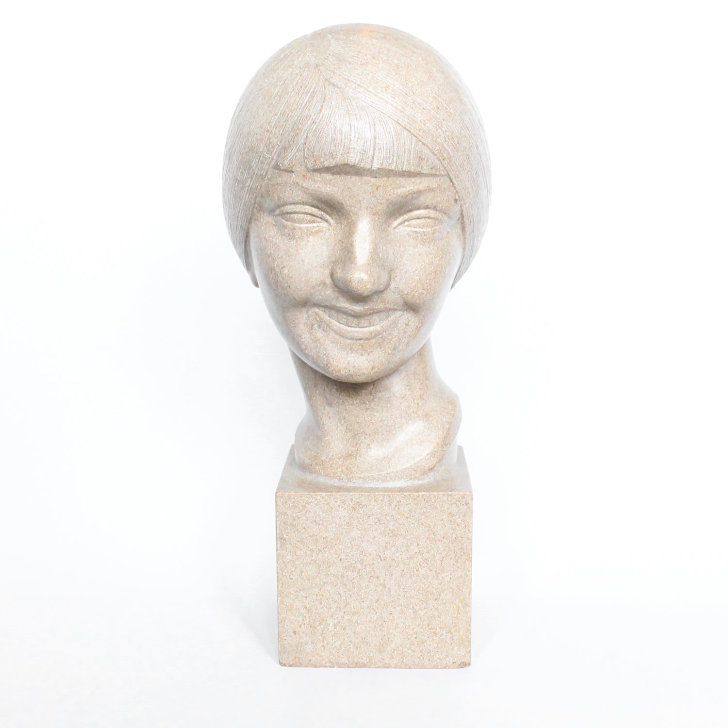 An Art Deco, stone carved sculpture of a smiling young lady, set over an integral plinth. Original dedication plaque to rear at Jeroen Markies.