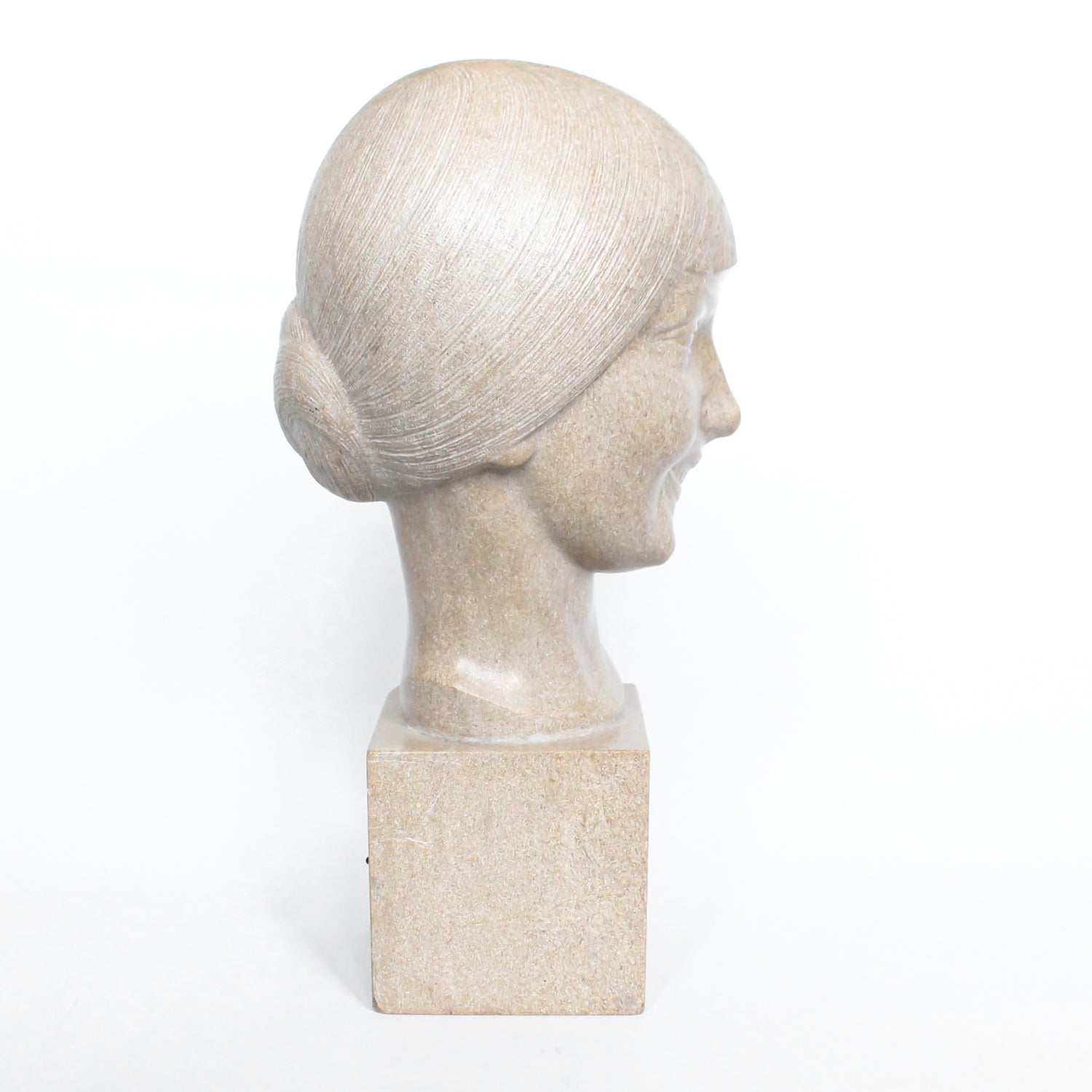 An Art Deco, stone carved sculpture of a smiling young lady, set over an integral plinth. Original dedication plaque to rear at Jeroen Markies.