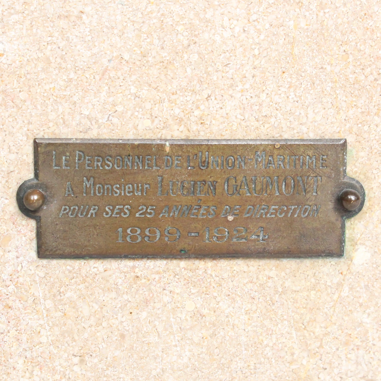 An Art Deco, stone carved sculpture of a smiling young lady, set over an integral plinth. Original dedication plaque to rear at Jeroen Markies.