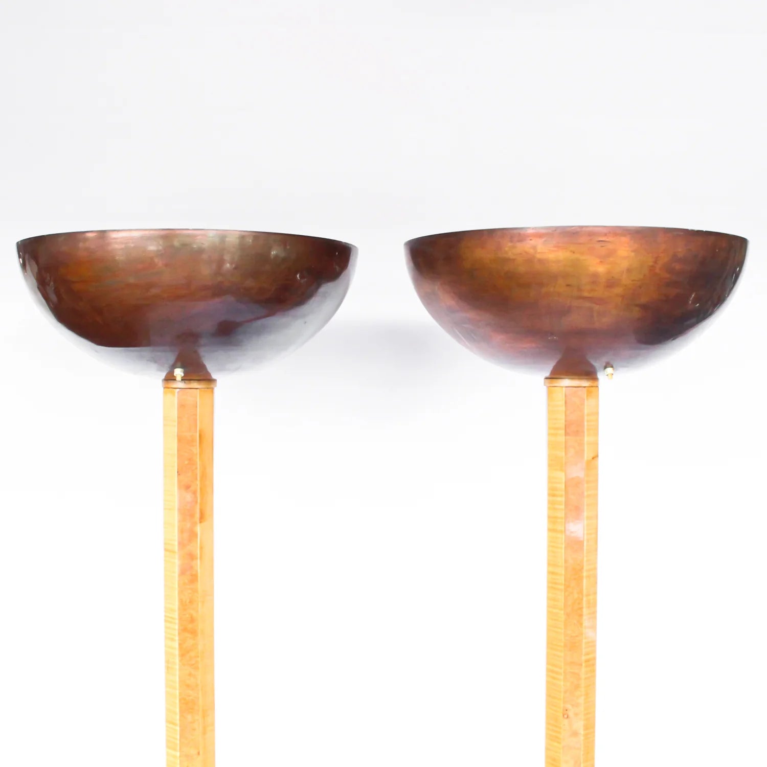 A pair of Art Deco uplighter floor lamps by Harry & Lou Epstein. Made of walnut and satin wood with domed copper shades.