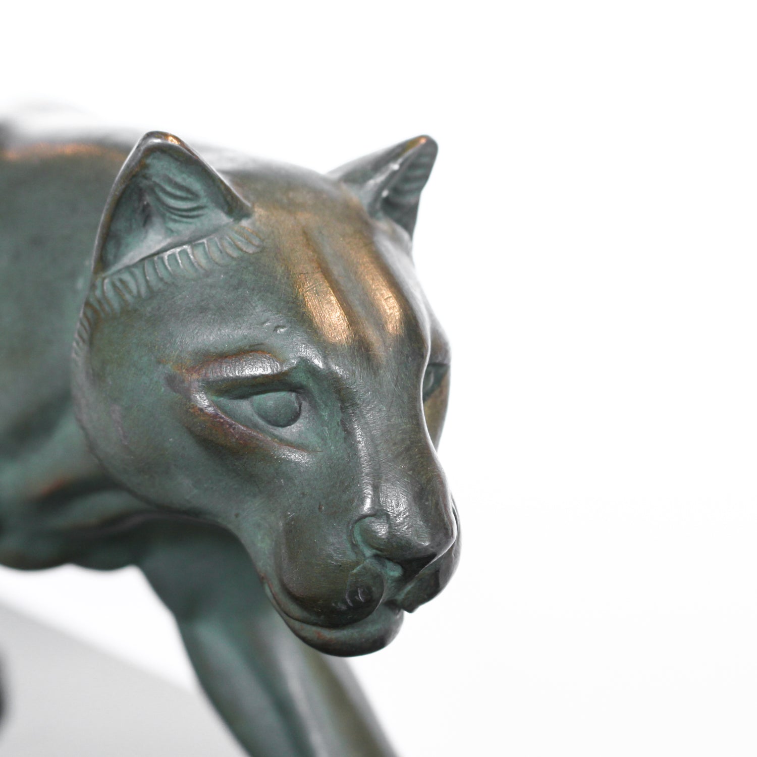 An Art Deco, patinated bronze study of a prowling lioness, mounted on a black marble base. Signed 'M. Leduc' at Jeroen Markies.