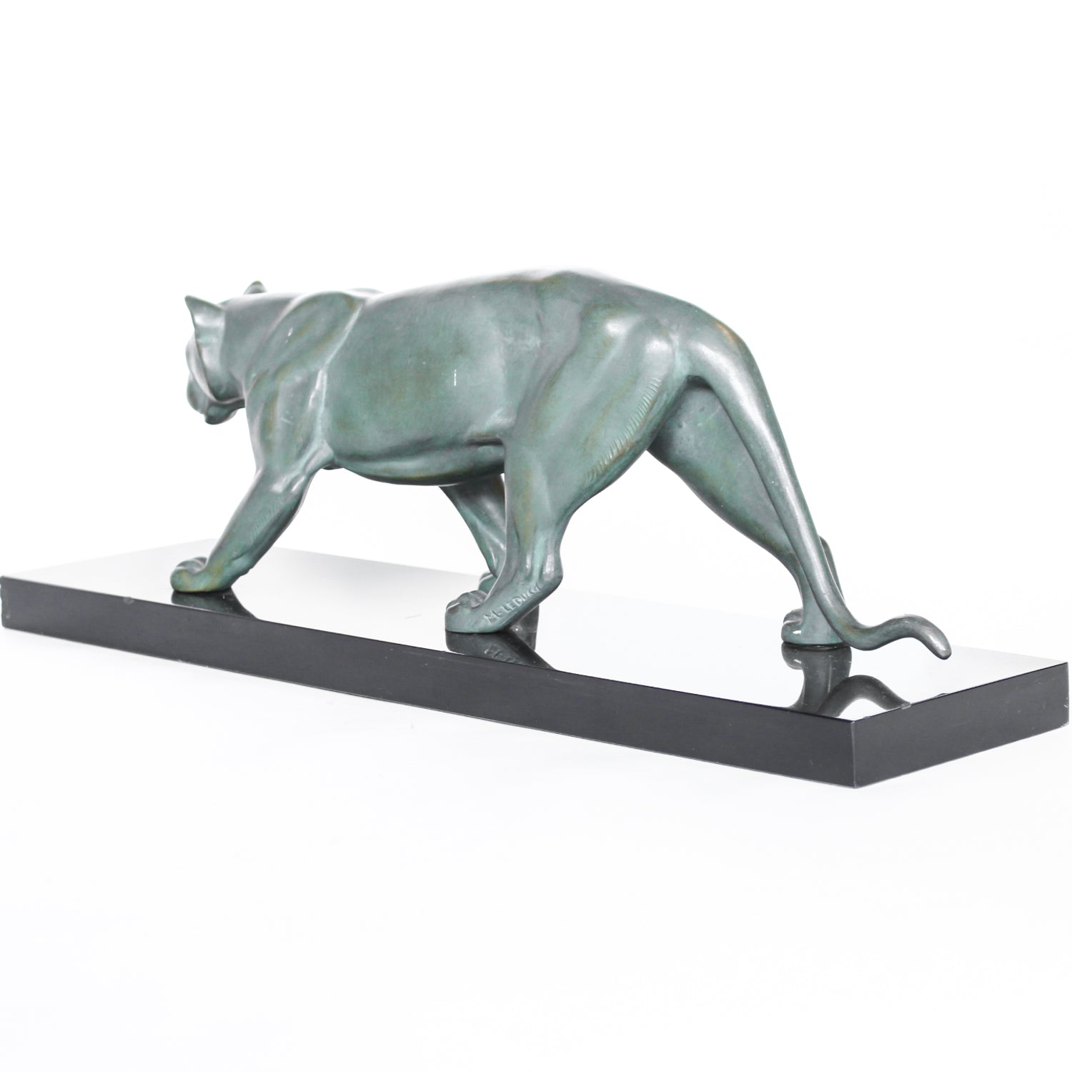 An Art Deco, patinated bronze study of a prowling lioness, mounted on a black marble base. Signed 'M. Leduc' at Jeroen Markies.