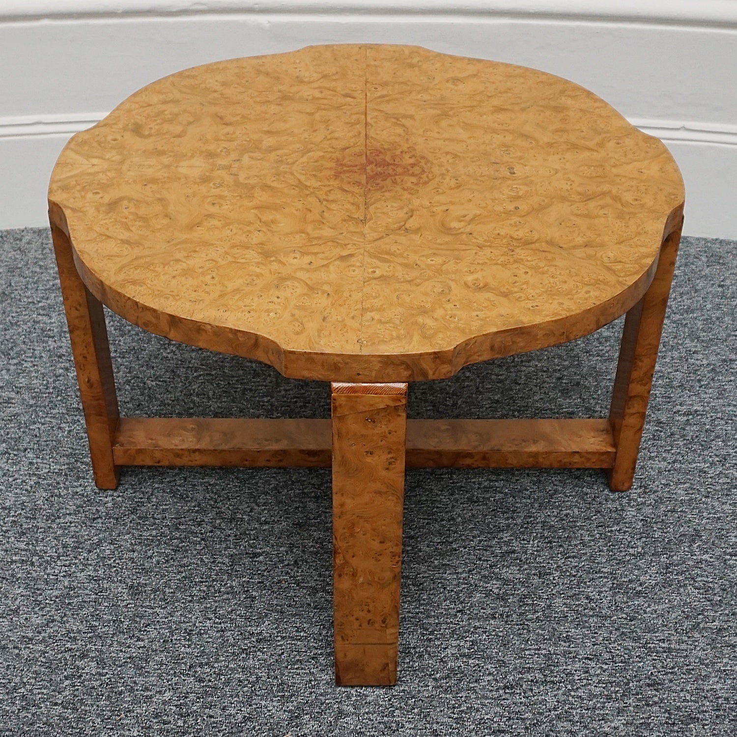 An Art Deco nest of tables by Harry & Lou Epstein Burr walnut veneered. Consisting of a central coffee table with four shelved pull out side tables. The tables have glass tops.