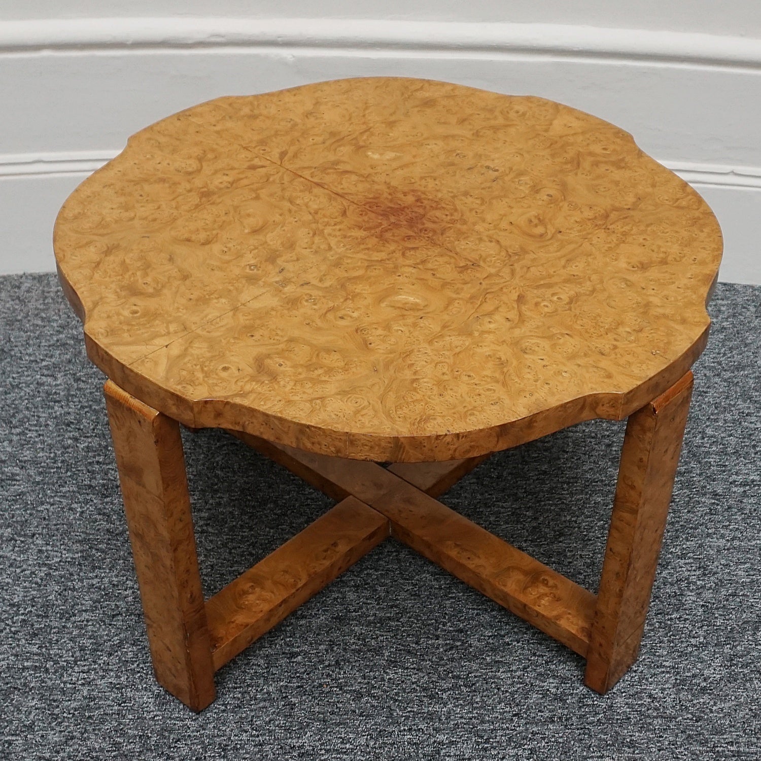 An Art Deco nest of tables by Harry & Lou Epstein Burr walnut veneered. Consisting of a central coffee table with four shelved pull out side tables. The tables have glass tops.