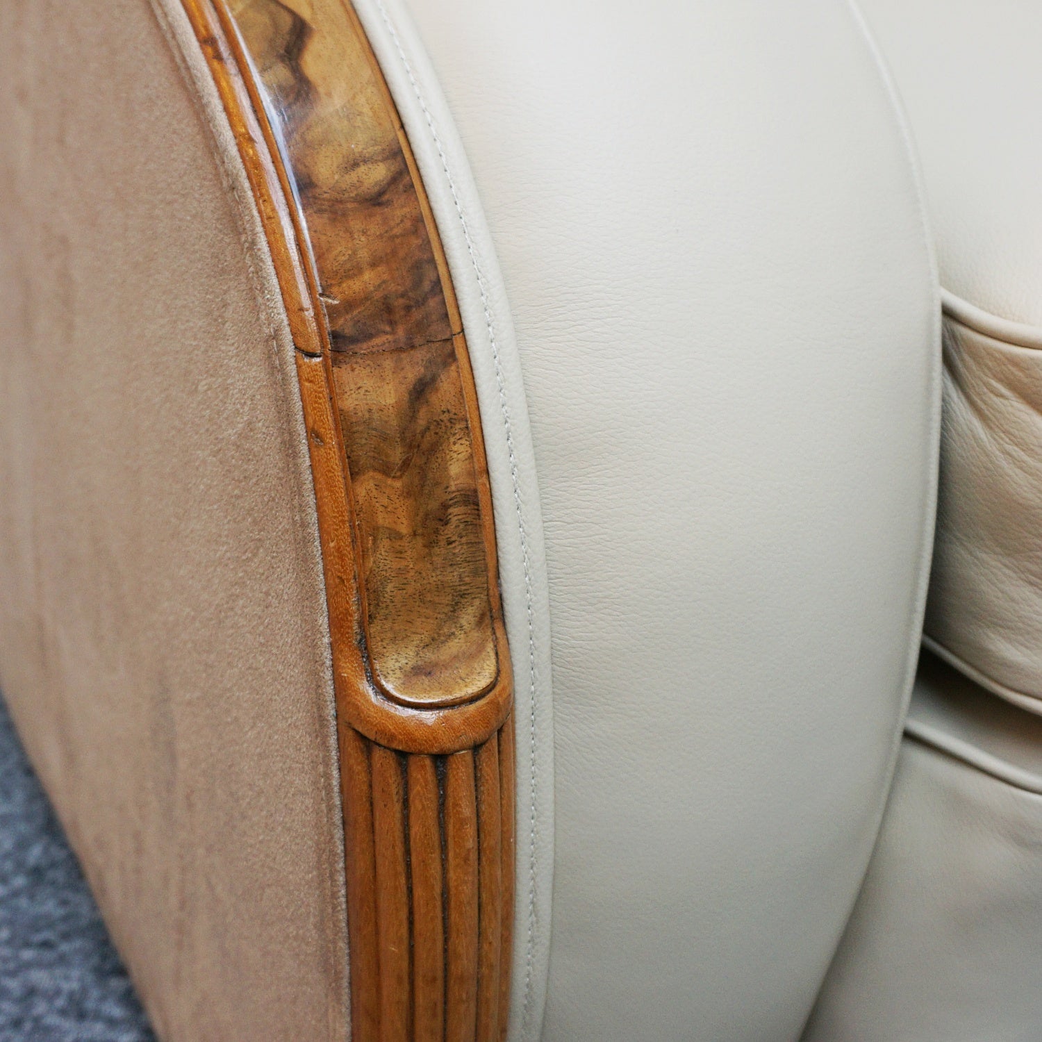 An Art Deco three piece tank suite by Heals of london. Made of Burr and solid walnut banding with reeded lower section, Upholstered in cream leather and contrasting faux suede