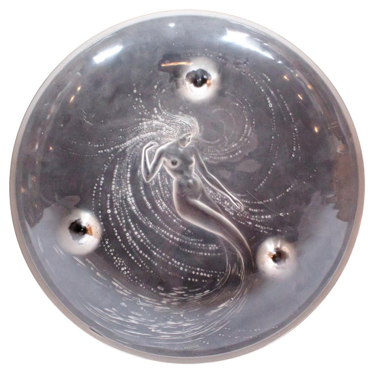 Sirene Coupe an Art Deco ‘trepied’ glass coupe by Lalique Glass of frosted glass with raised opalescent design in the form of a mermaid frolicking in swirling waters set on three raised feet.