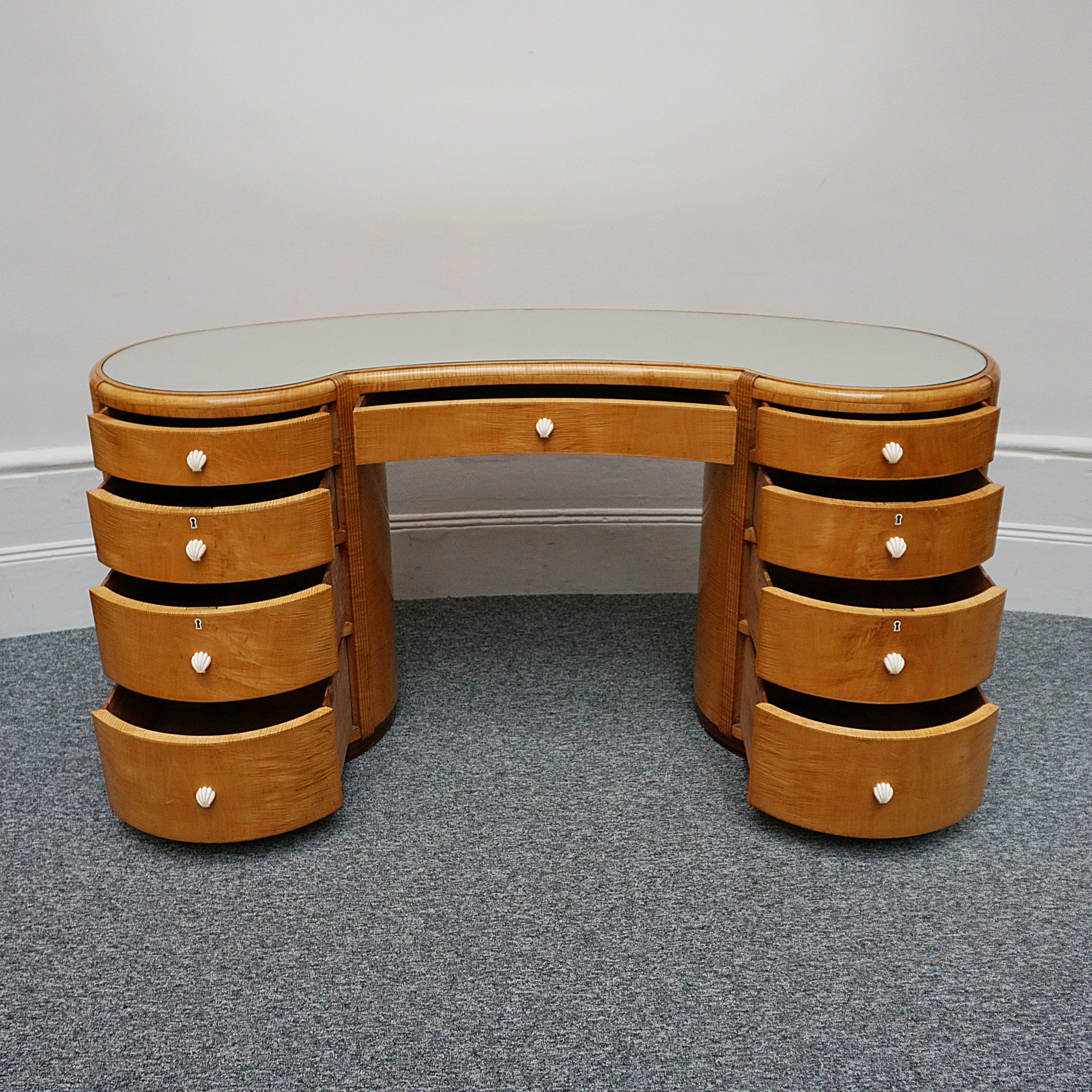 An Art Deco Desk by Betty Joel. Satin birch veneered with macassar ebony banding to base. Glass mirrored top with original ivory hand carved shell handles. 1930 dressing table, art deco desk - Jeroen Markies Art Deco