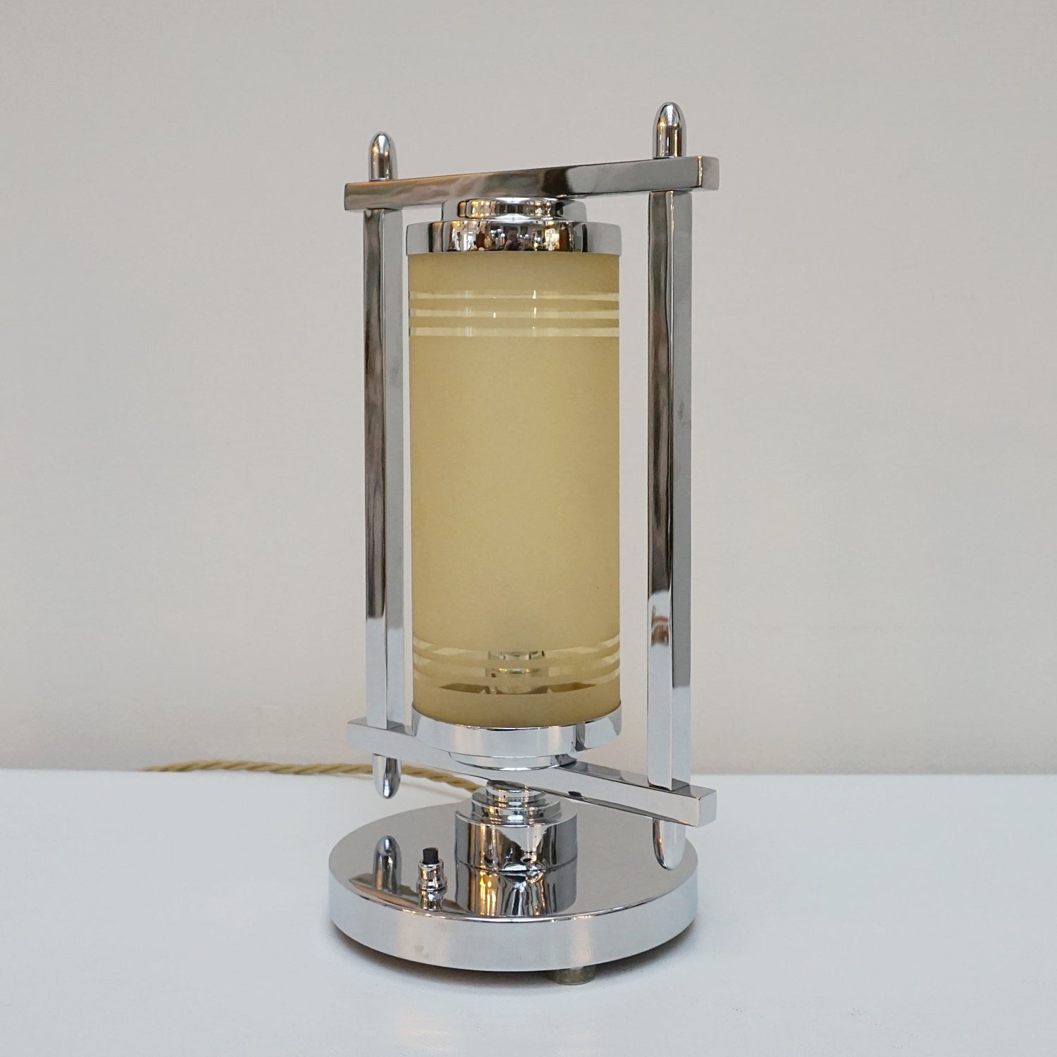 Squared chrome frame with cylindrical yellow glass inner shade. 