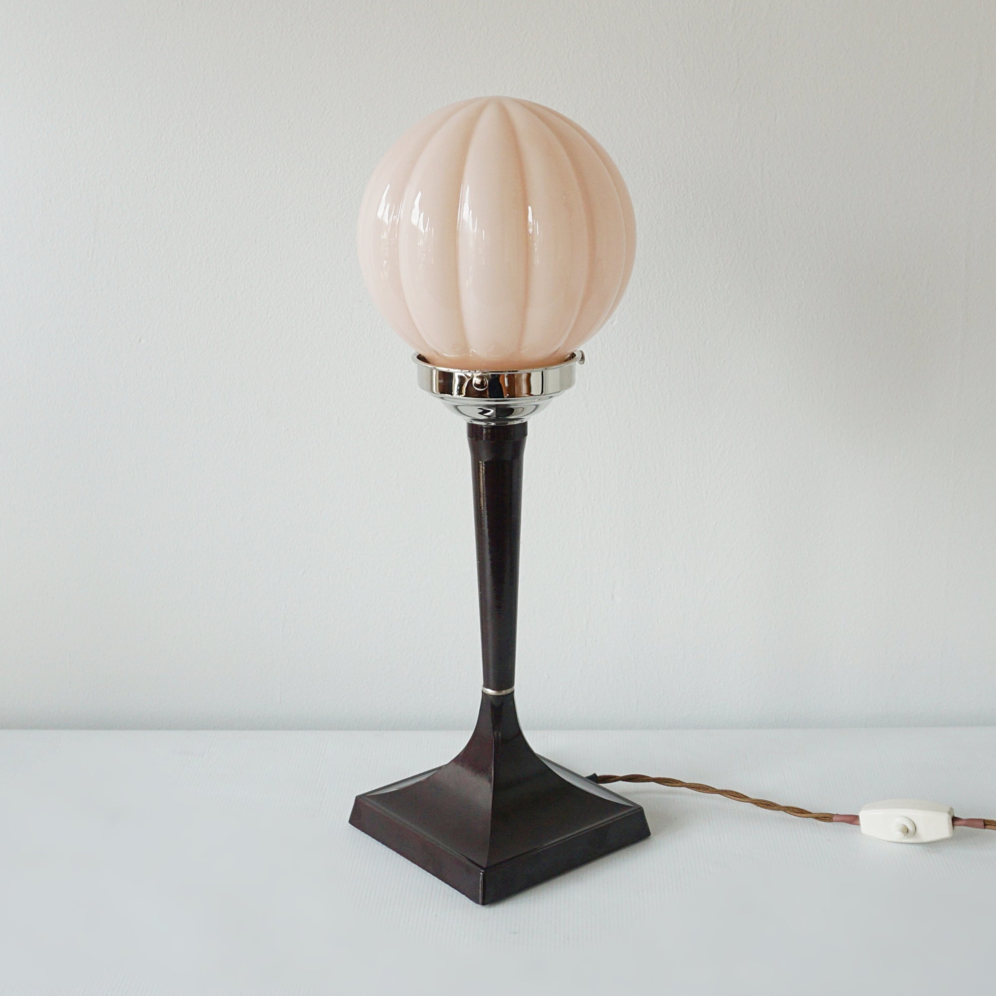 An Art Deco style table lamp. Brown bakelite square stem with peach pink glass globe shade - Jeroen Markies Art Deco