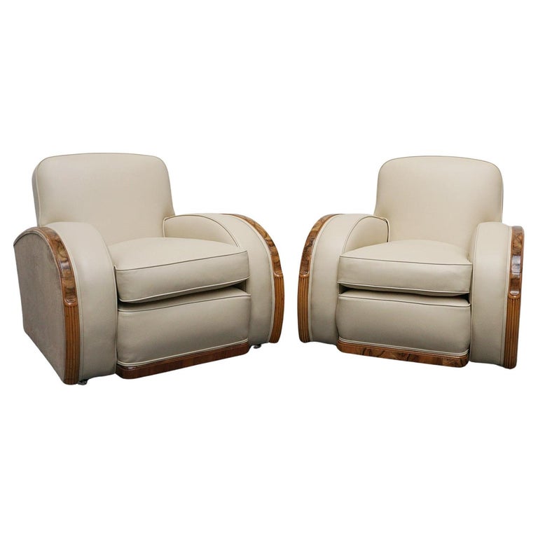 An Art Deco tank chairs by Heals of london. Made of Burr and solid walnut banding with reeded lower section, Upholstered in cream leather and contrasting faux suede