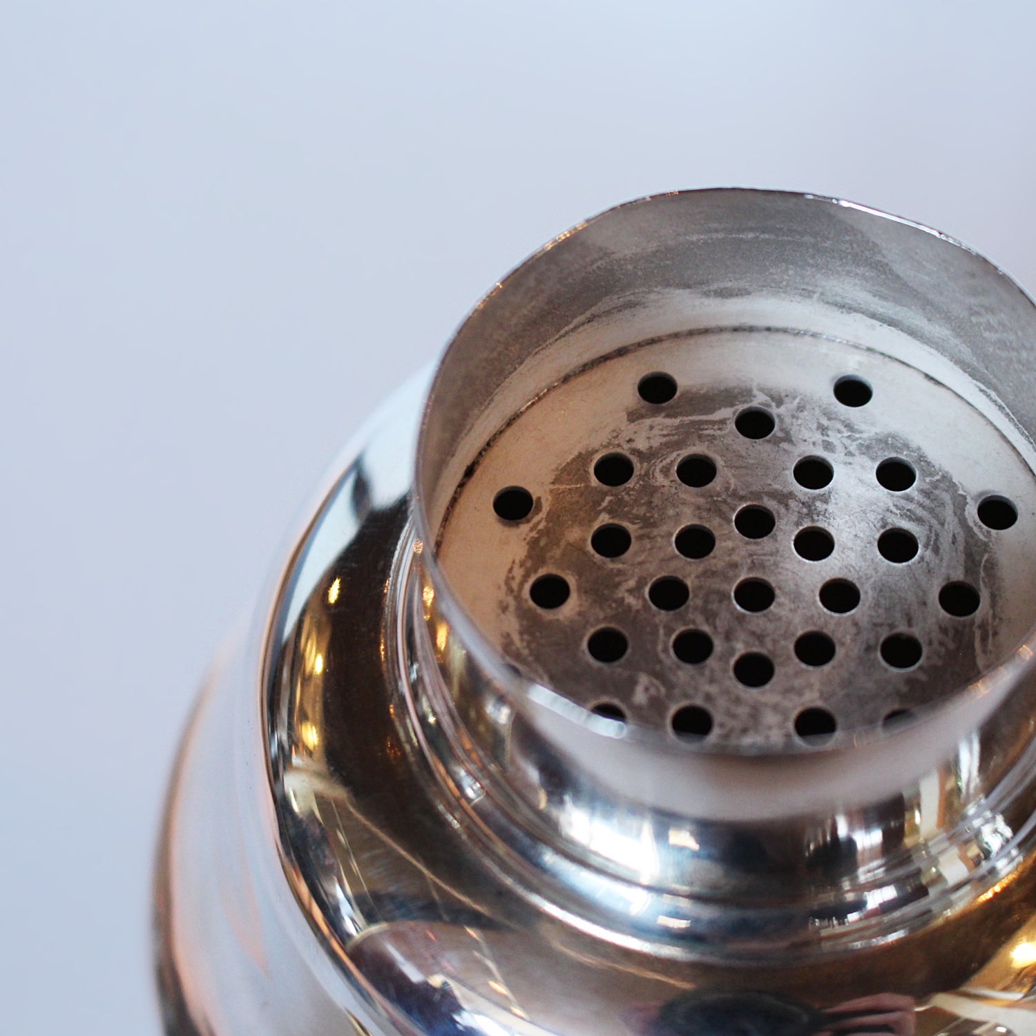 An Art Deco, silver plated and gilt recipe cocktail shaker. Integral strainer. Outer  sliver plated cover revealing brass underlayer with ingredients for various cocktails. Stamped 'Napier' to underside at Jeroen Markies.