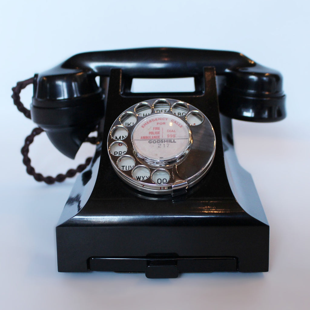 An original GPO telephone in black bakelite. With integral drawer.