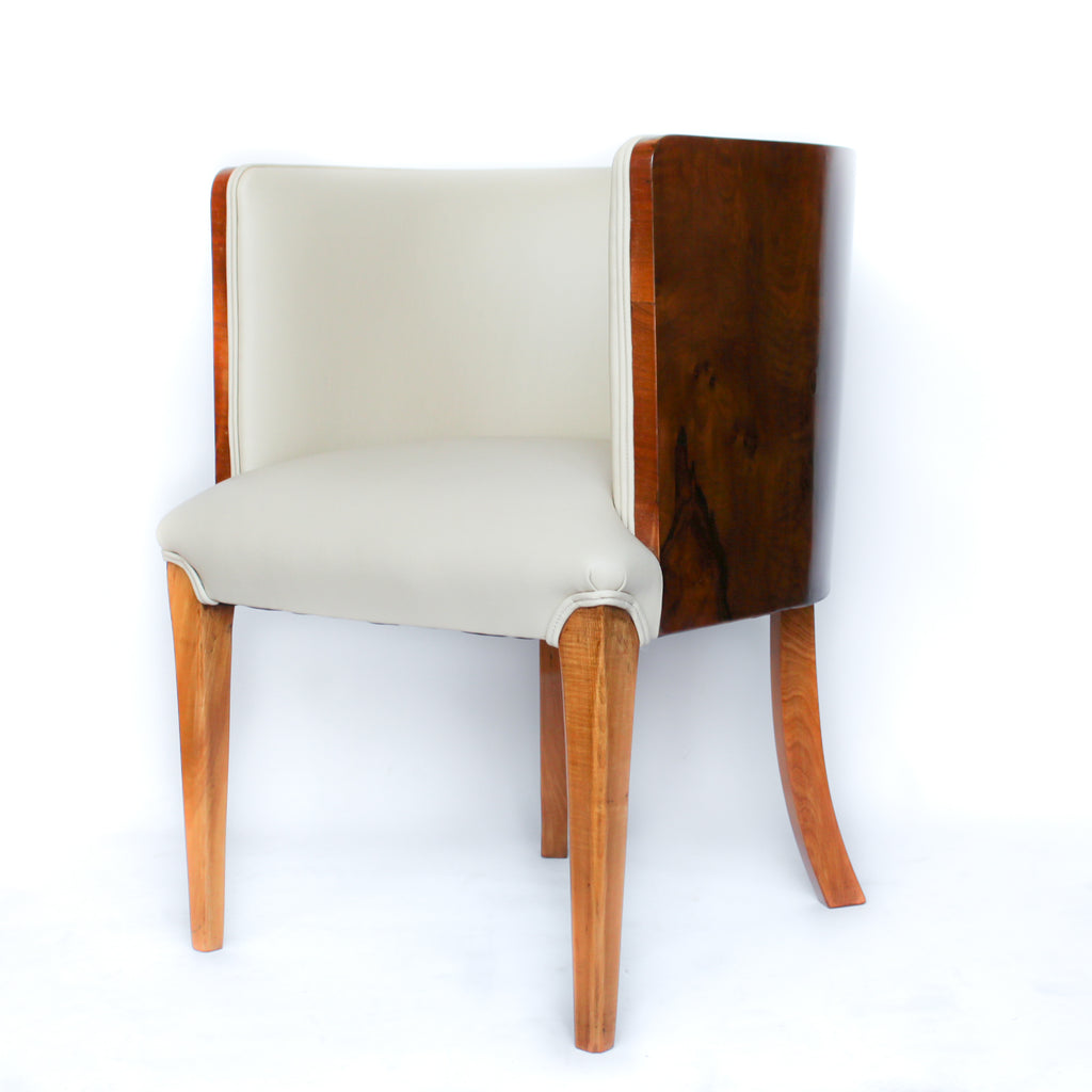A pair of Art Deco tub chairs. Veneered walnut wrap frame. Solid satin birch legs. Upholstered in cream leather at Jeroen Markies.