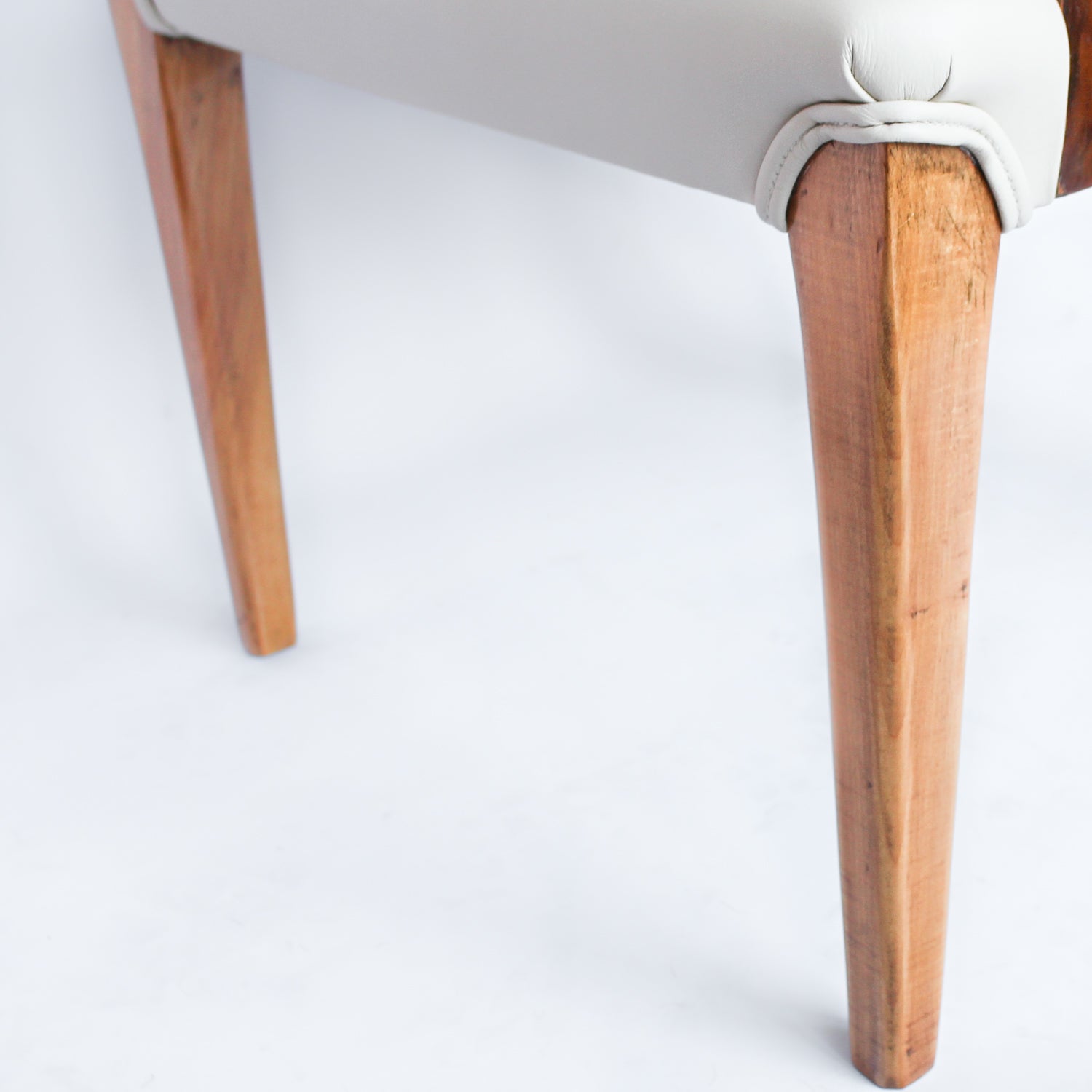 A pair of Art Deco tub chairs. Veneered walnut wrap frame. Solid satin birch legs. Upholstered in cream leather at Jeroen Markies.