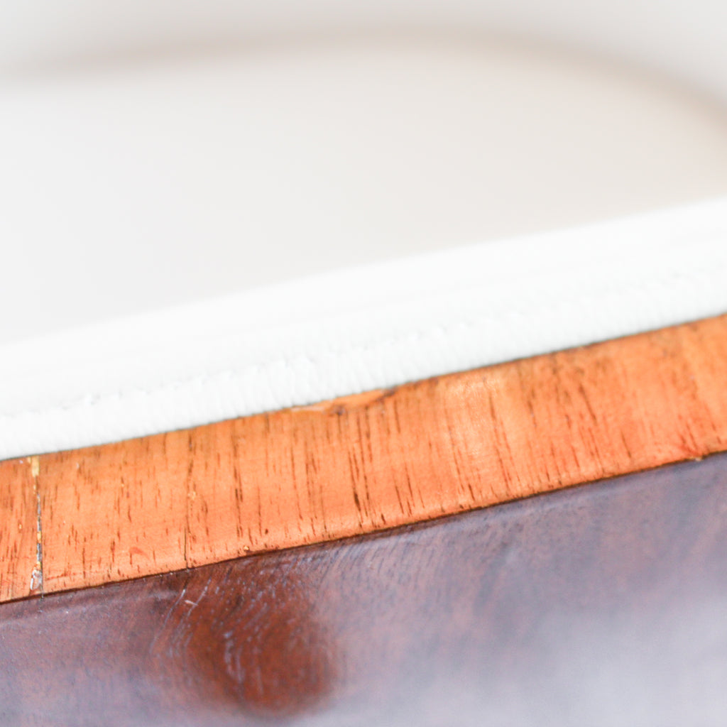 A pair of Art Deco tub chairs. Veneered walnut wrap frame. Solid satin birch legs. Upholstered in cream leather at Jeroen Markies.