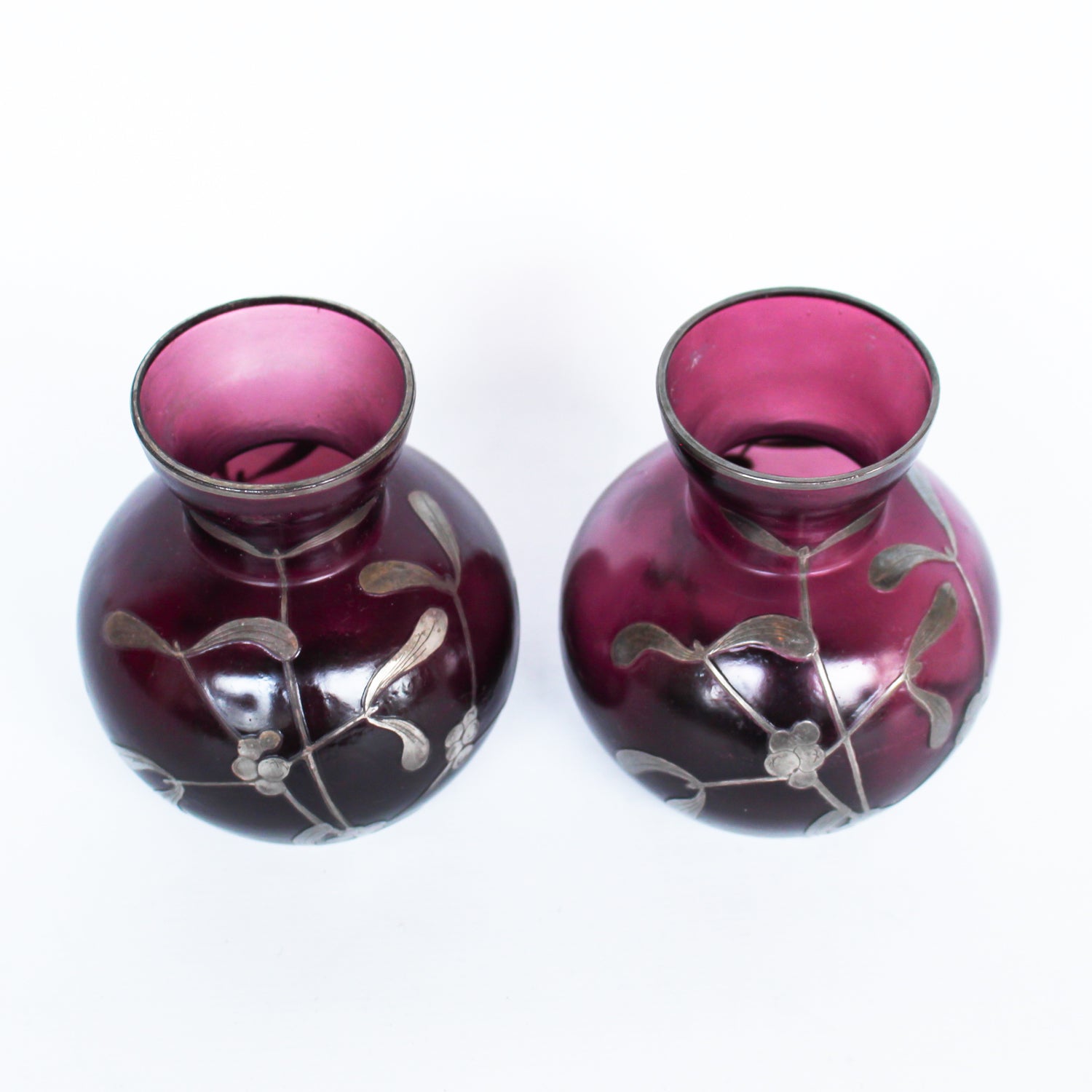 A pair of Art Deco bohemian purple hued glass vases with silver overlay mistletoe design at Jeroen Markies
