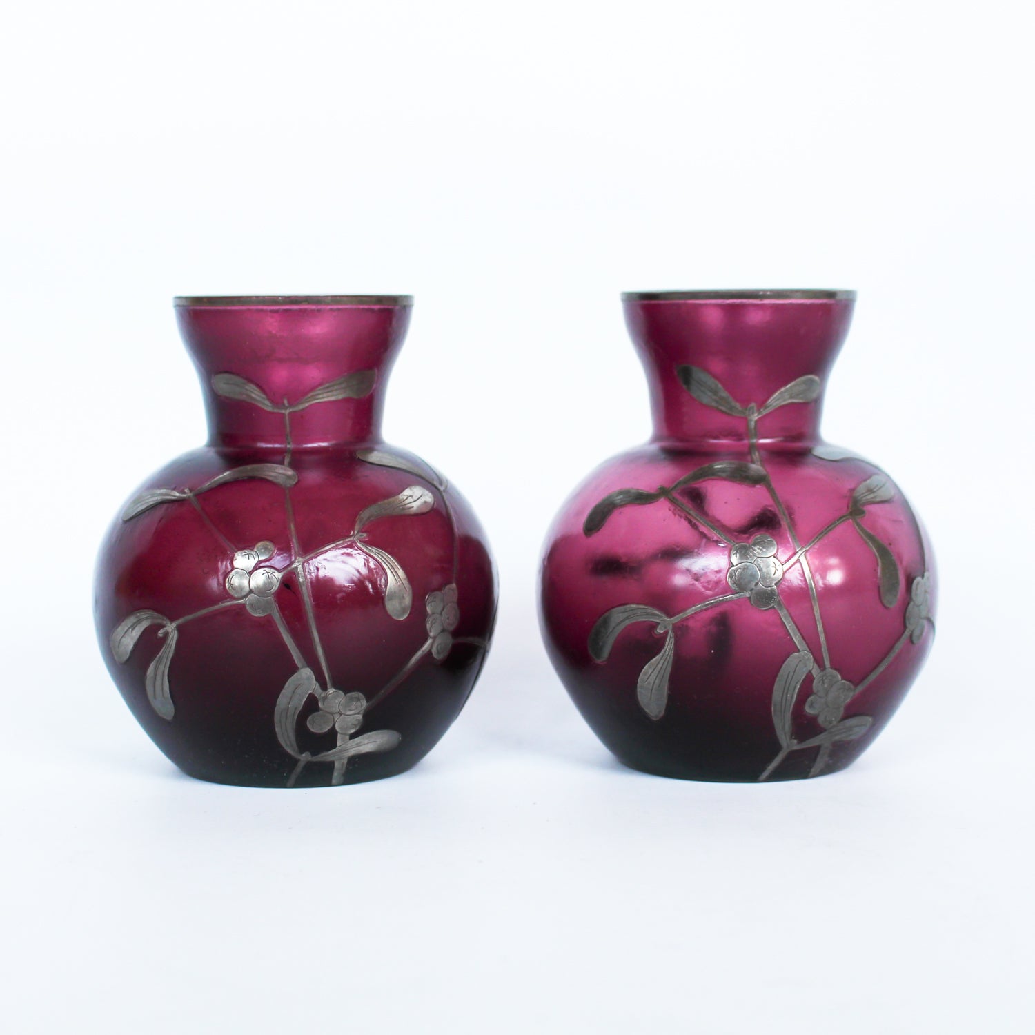 A pair of Art Deco bohemian purple hued glass vases with silver overlay mistletoe design at Jeroen Markies