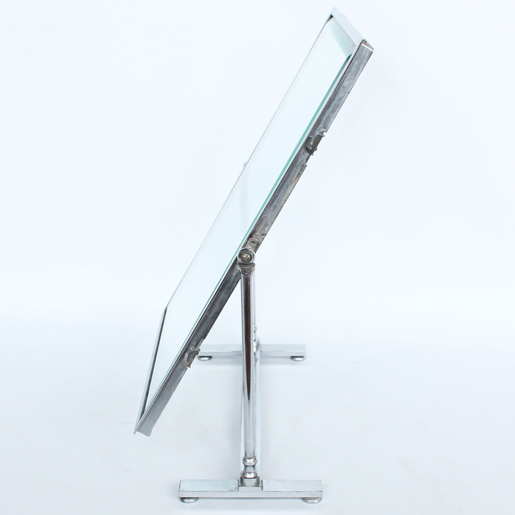 An Art Deco photo frame, on a chrome base, beveled glass liners at Jeroen Markies.