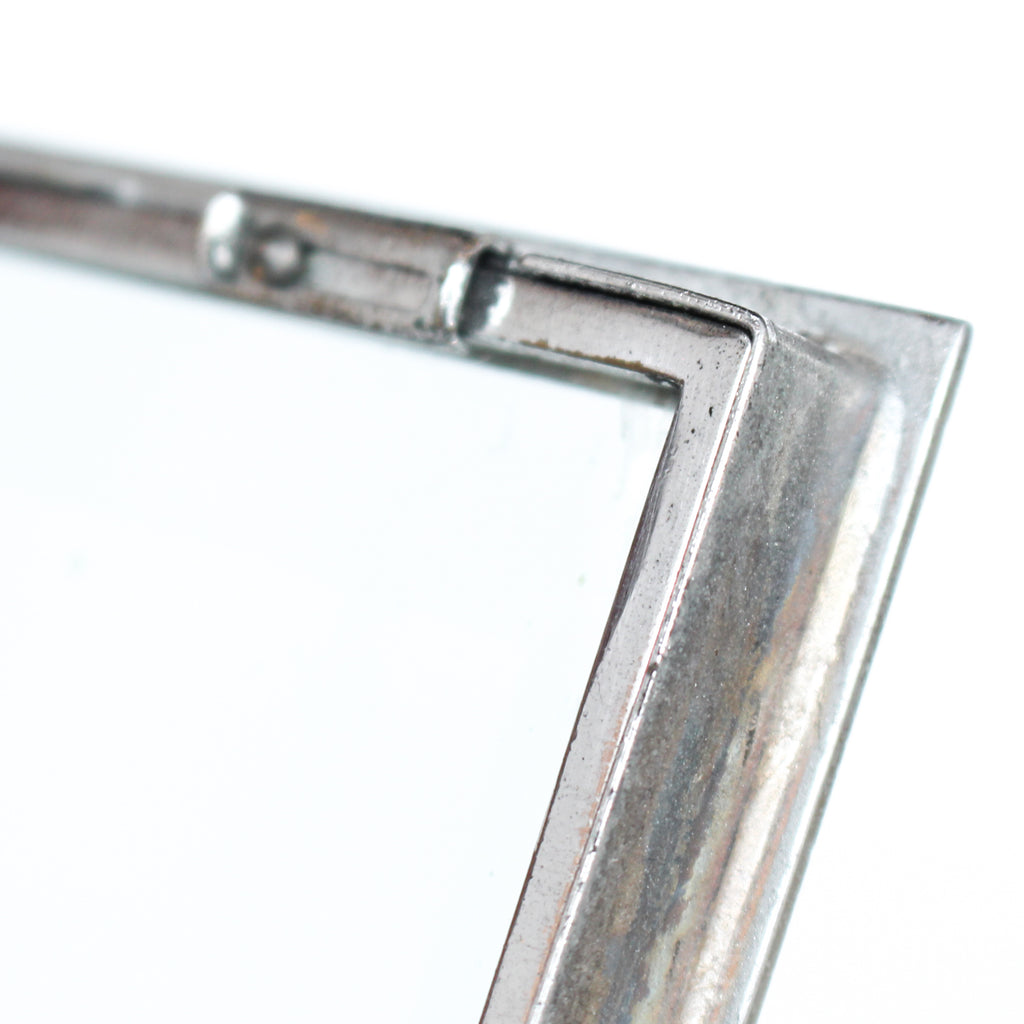 An Art Deco photo frame, on a chrome base, beveled glass liners at Jeroen Markies.