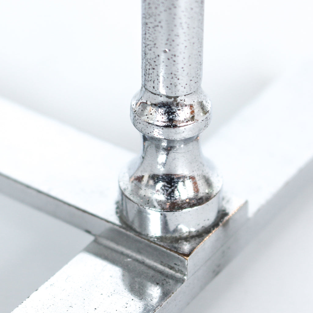 An Art Deco photo frame, on a chrome base, beveled glass liners at Jeroen Markies.