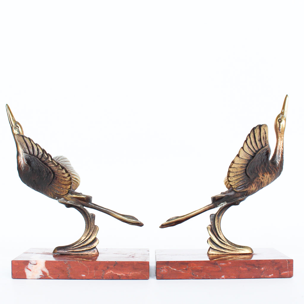 A pair of Art Deco, bronze bookends in the form of two marabou storks. Set over marble plinths. 