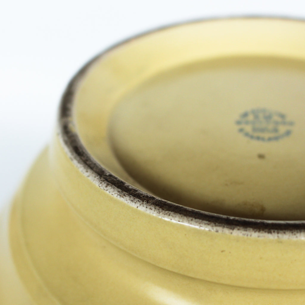 A Keith Murray design vase for wedgewood , sometimes known as football vase with deep horizontal ribs in a cream glaze. Full signature underneath at Jeroen Markies.