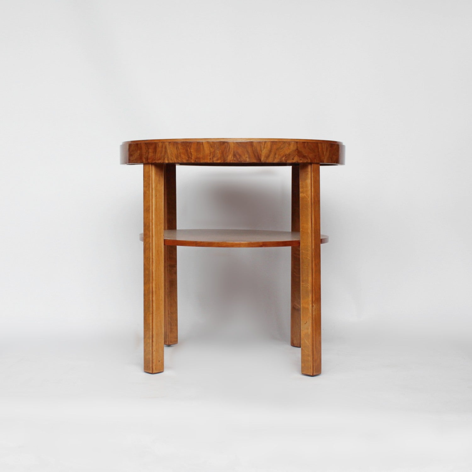 An Art Deco circular side table with shelf circa 1930