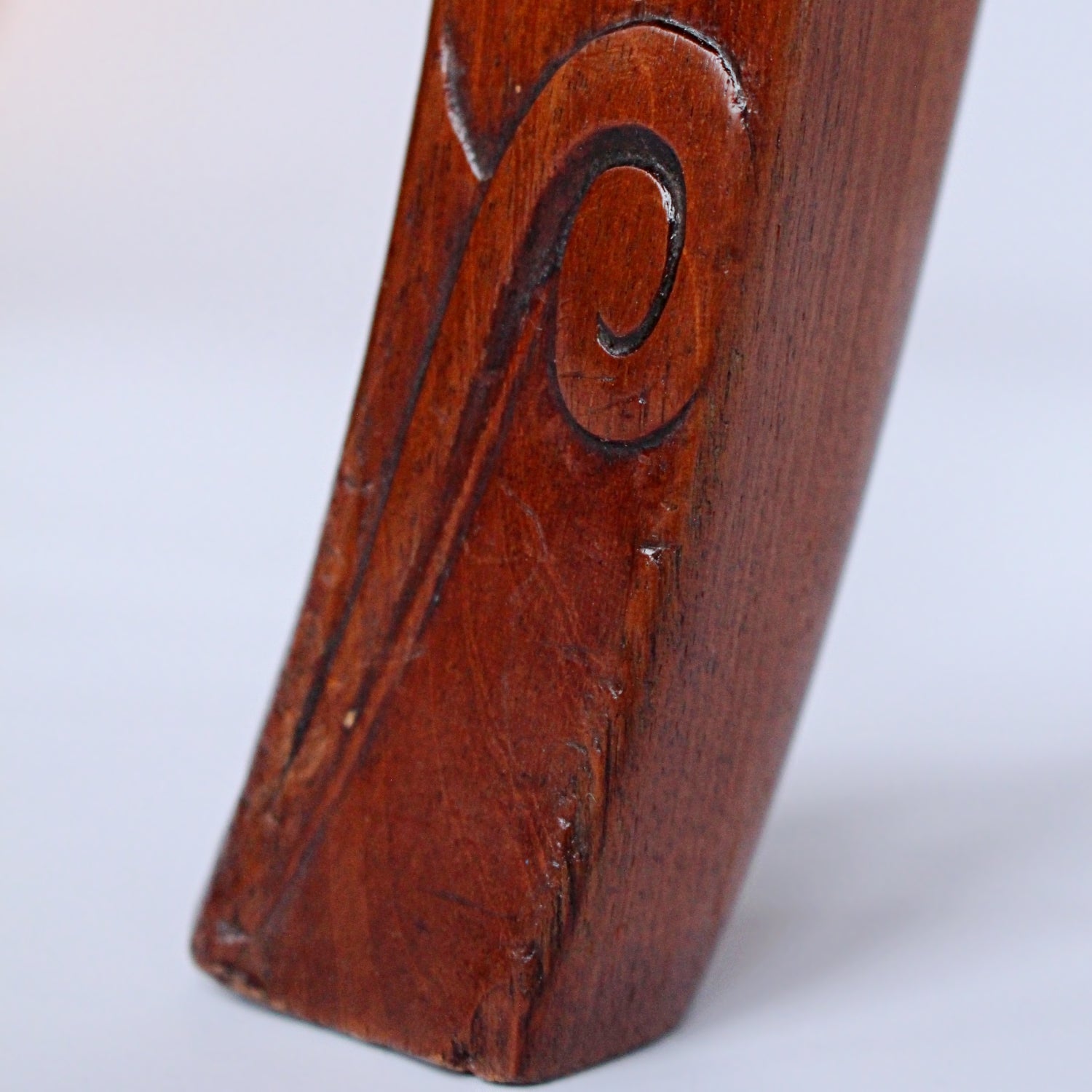 A pair of side chairs with walnut frames. Scrolled and carved detail to frames. Upholstered in cream leather. 
