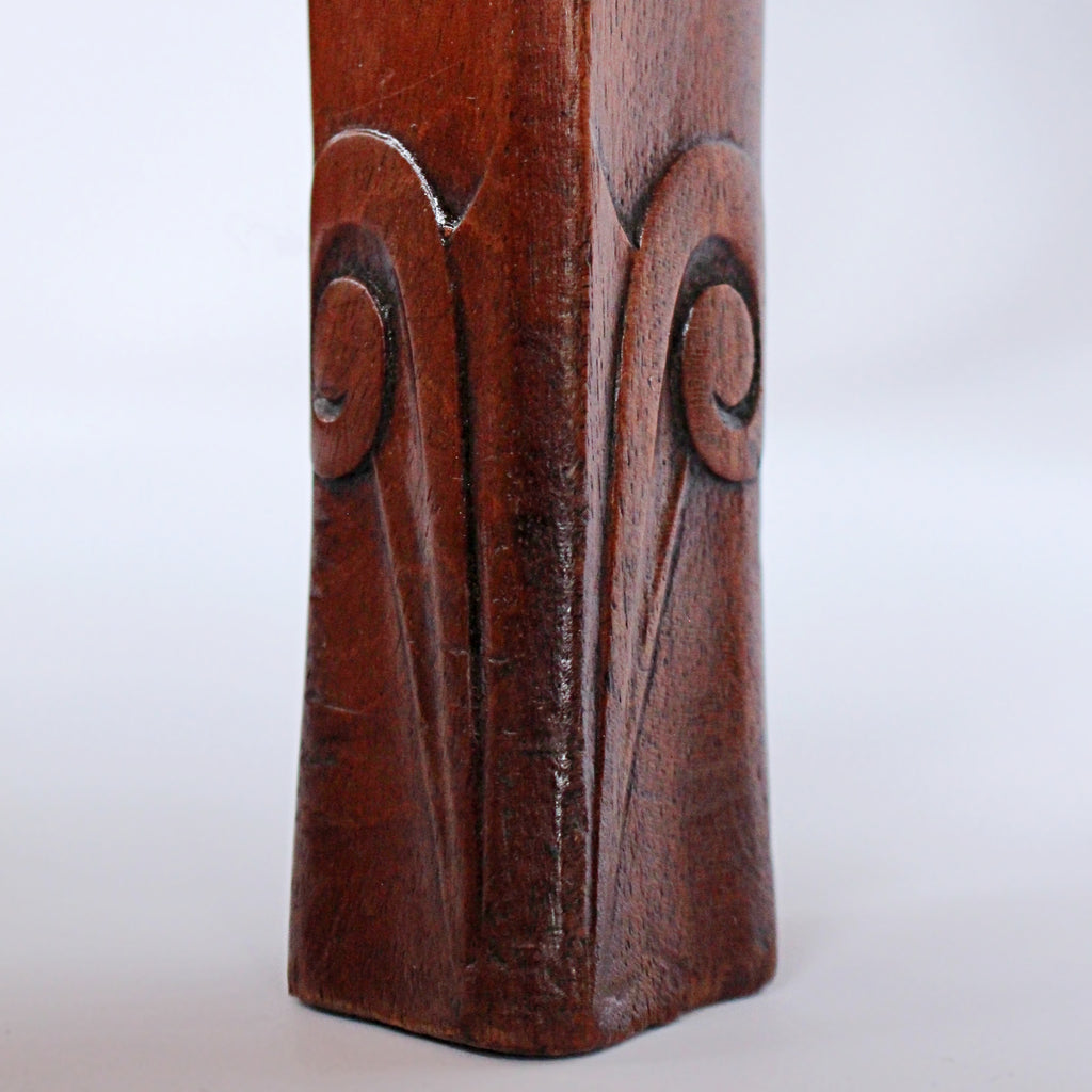 A pair of side chairs with walnut frames. Scrolled and carved detail to frames. Upholstered in cream leather. 