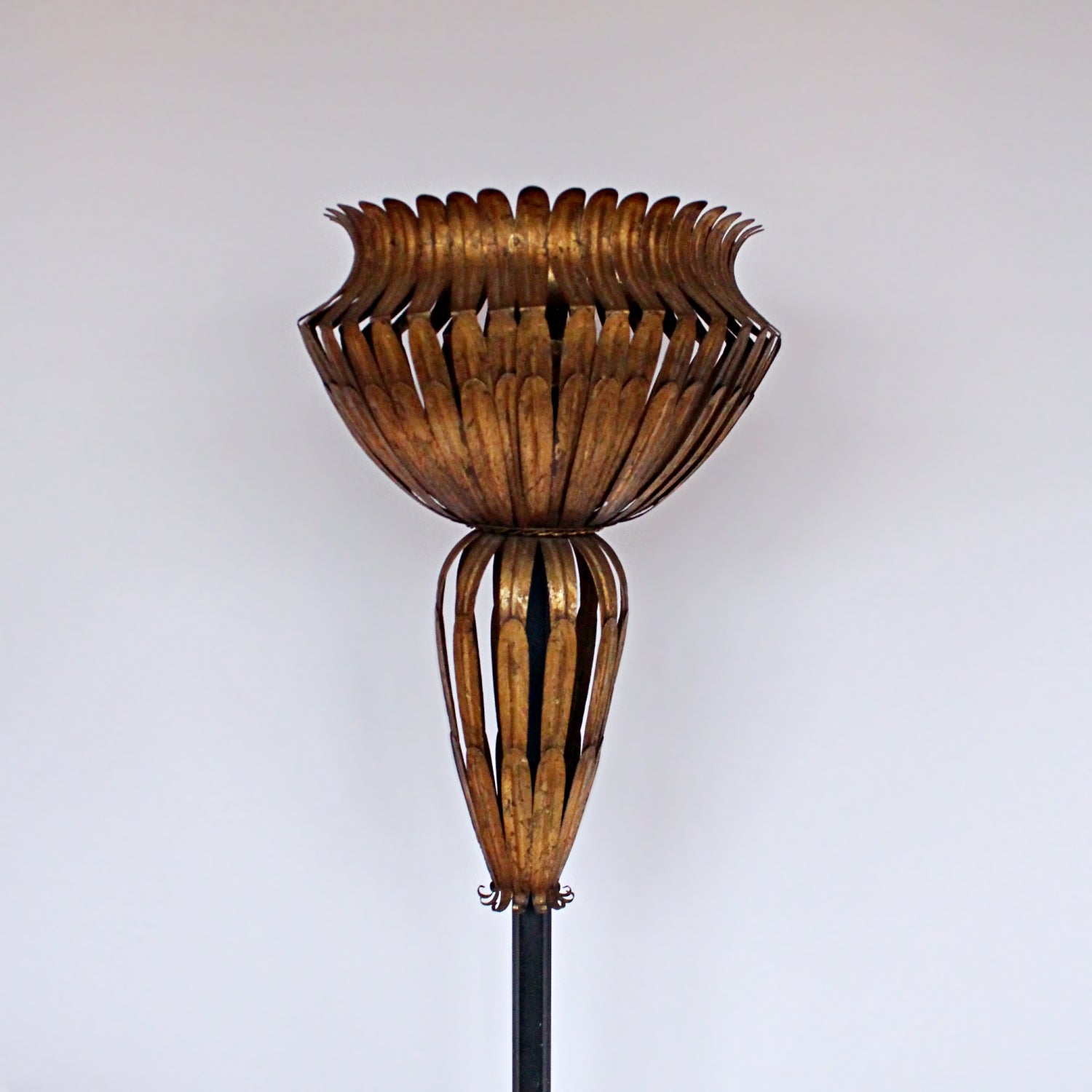 A pair of 20th Century gilt metal and cast iron floor lamps. Iron stem and base. Caged, stylised shades.