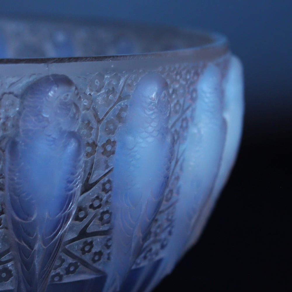A frosted an opalescent glass bowl depicting parakeets in relief. Hand etched 'R Lalique France' to underside at Jeroen Markies