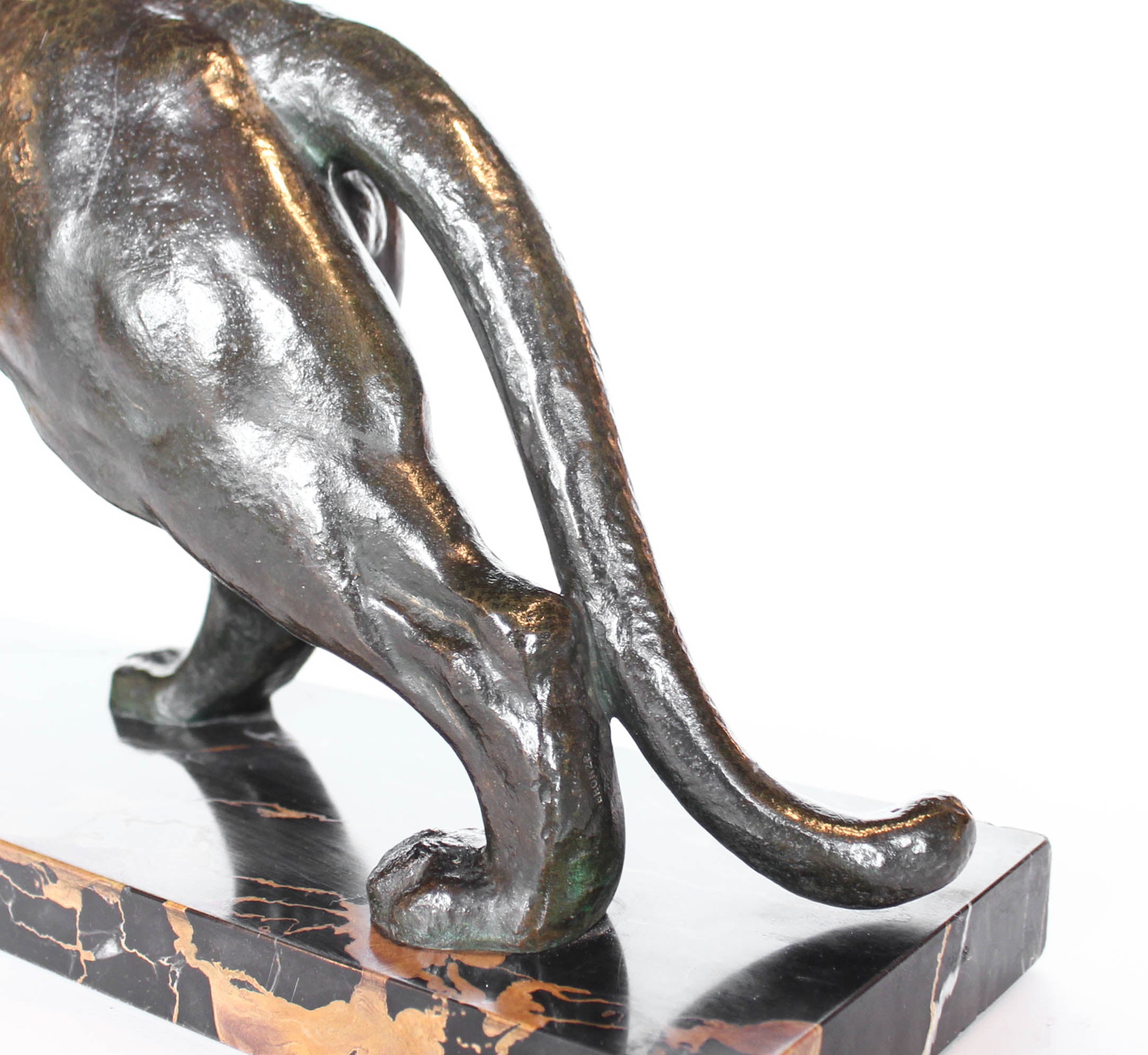 An Art Deco, patinated bronze study of a prowling tiger, set over an integral marble base. Signed to marble at Jeroen Markies