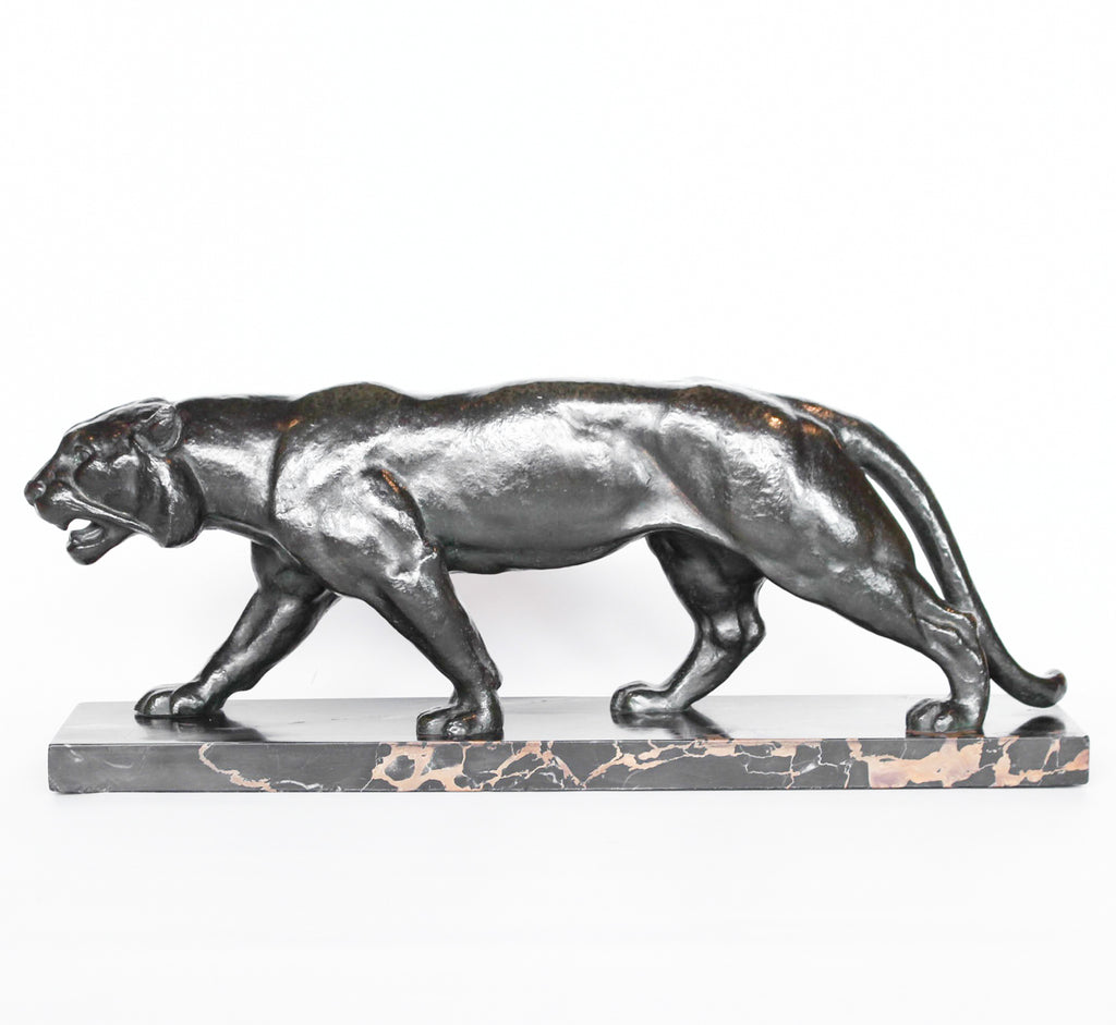 An Art Deco, patinated bronze study of a prowling tiger, set over an integral marble base. Signed to marble at Jeroen Markies