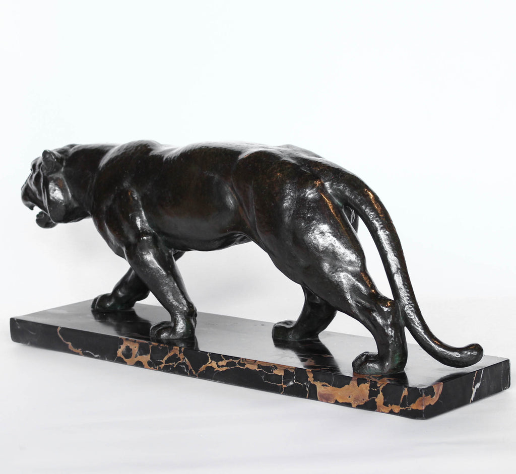 An Art Deco, patinated bronze study of a prowling tiger, set over an integral marble base. Signed to marble at Jeroen Markies