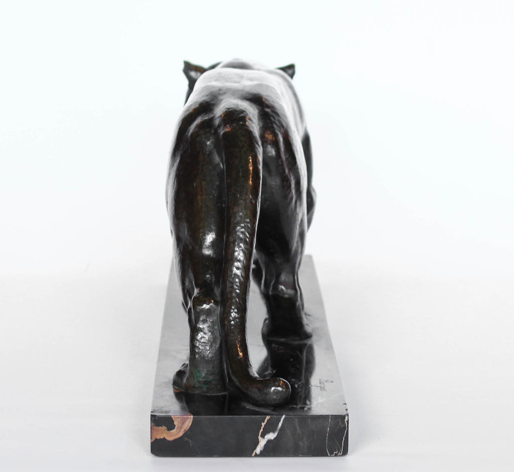 An Art Deco, patinated bronze study of a prowling tiger, set over an integral marble base. Signed to marble at Jeroen Markies