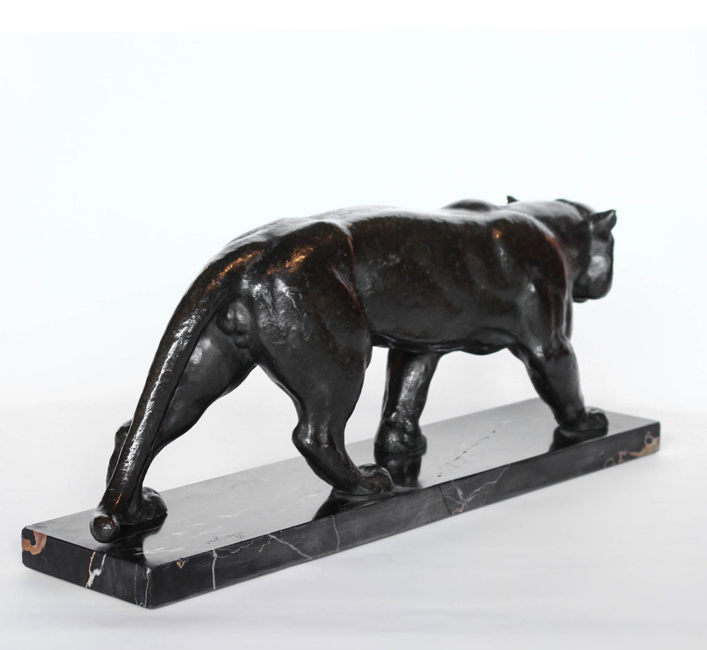 An Art Deco, patinated bronze study of a prowling tiger, set over an integral marble base. Signed to marble at Jeroen Markies