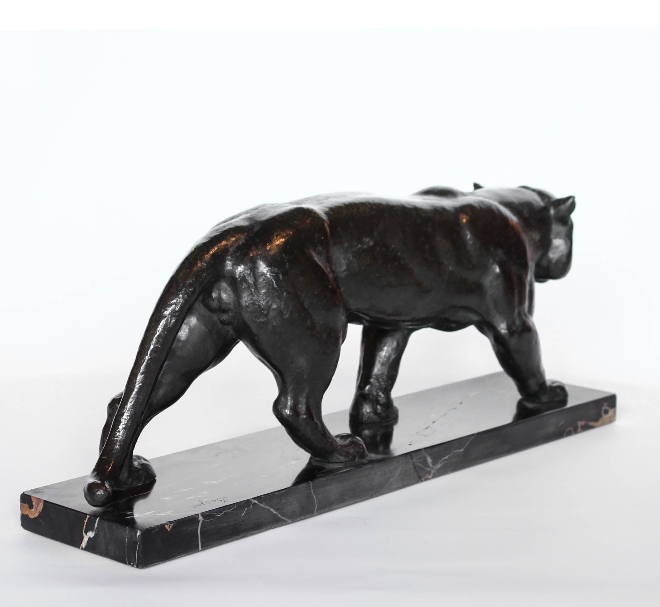 An Art Deco, patinated bronze study of a prowling tiger, set over an integral marble base. Signed to marble at Jeroen Markies
