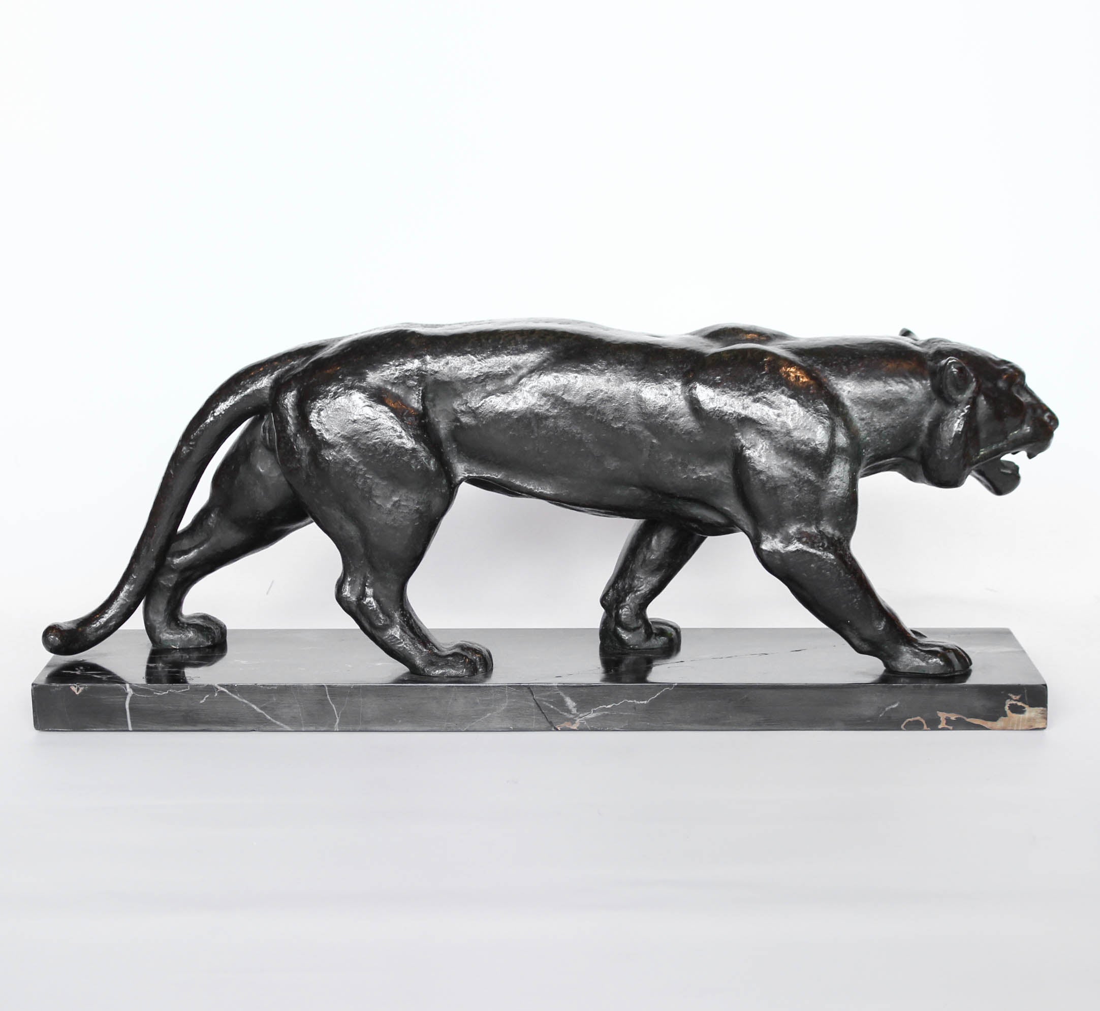 An Art Deco, patinated bronze study of a prowling tiger, set over an integral marble base. Signed to marble at Jeroen Markies