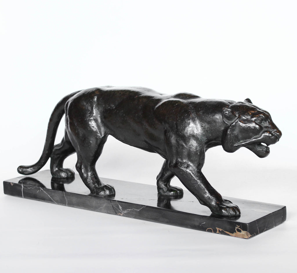 An Art Deco, patinated bronze study of a prowling tiger, set over an integral marble base. Signed to marble at Jeroen Markies