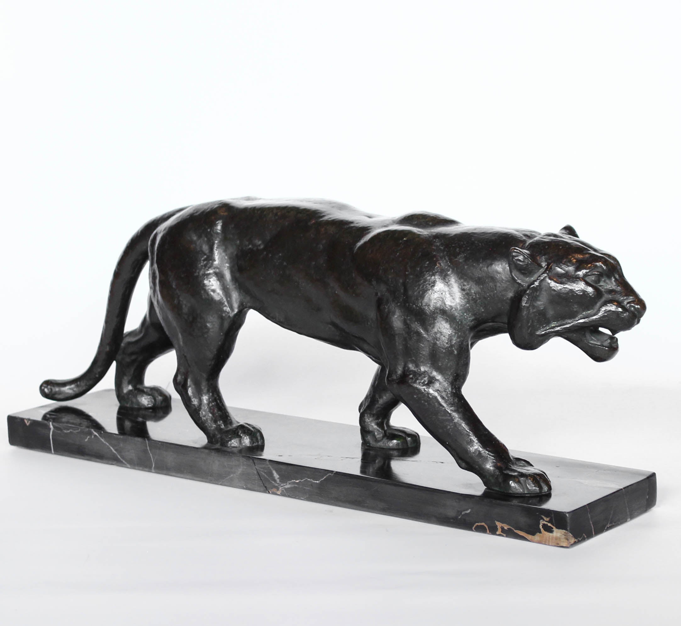 An Art Deco, patinated bronze study of a prowling tiger, set over an integral marble base. Signed to marble at Jeroen Markies
