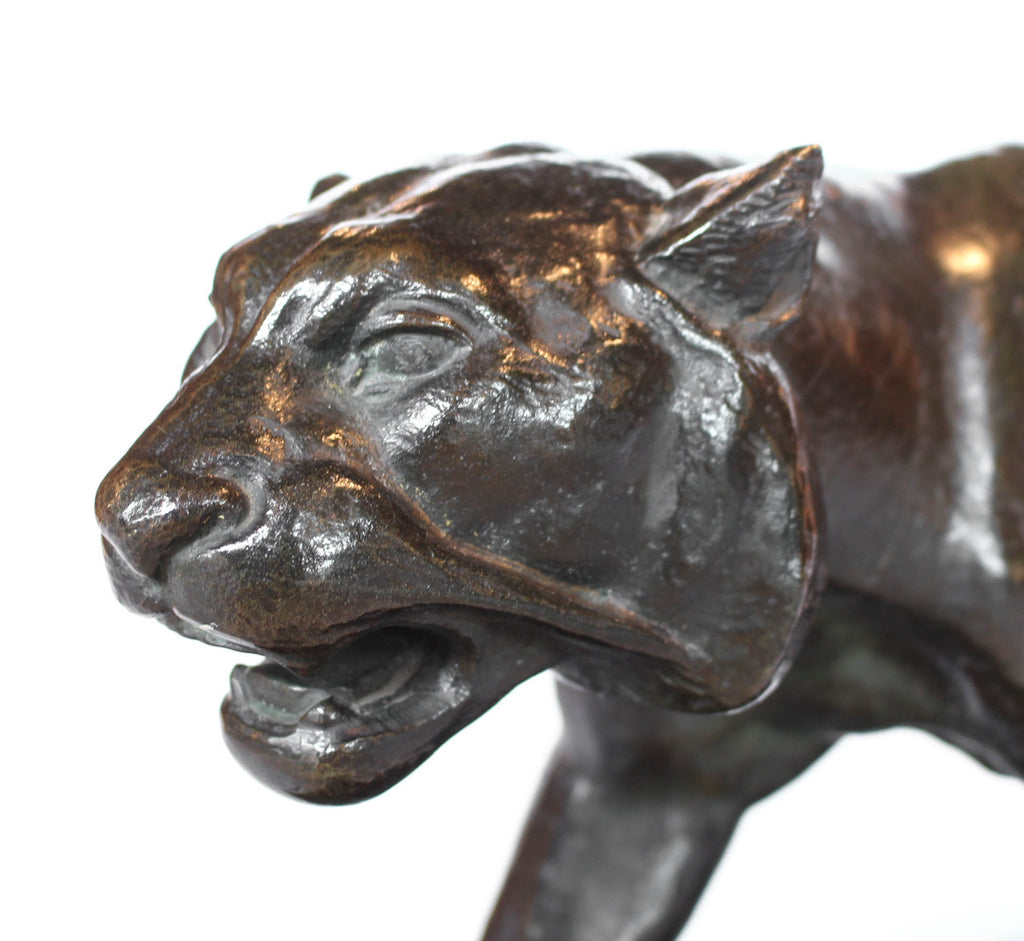 An Art Deco, patinated bronze study of a prowling tiger, set over an integral marble base. Signed to marble at Jeroen Markies