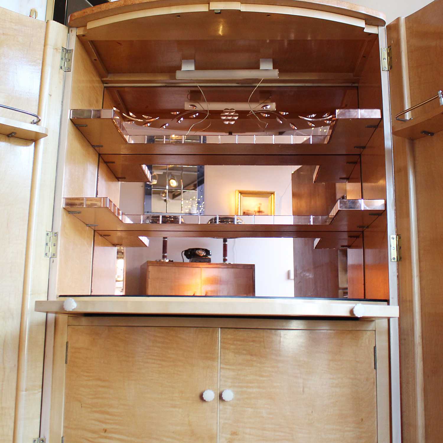 Art Deco cocktail cabinet by Harry & Lou Epstein with bow front and peach glass interior at Jeroen Markies