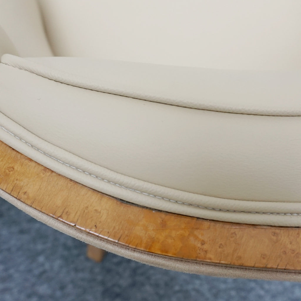 A pair of Art Deco bankers chairs birdseye maple veneered with solid satin birch legs. Upholstered in cream leather and contrasting oatmeal faux suede.